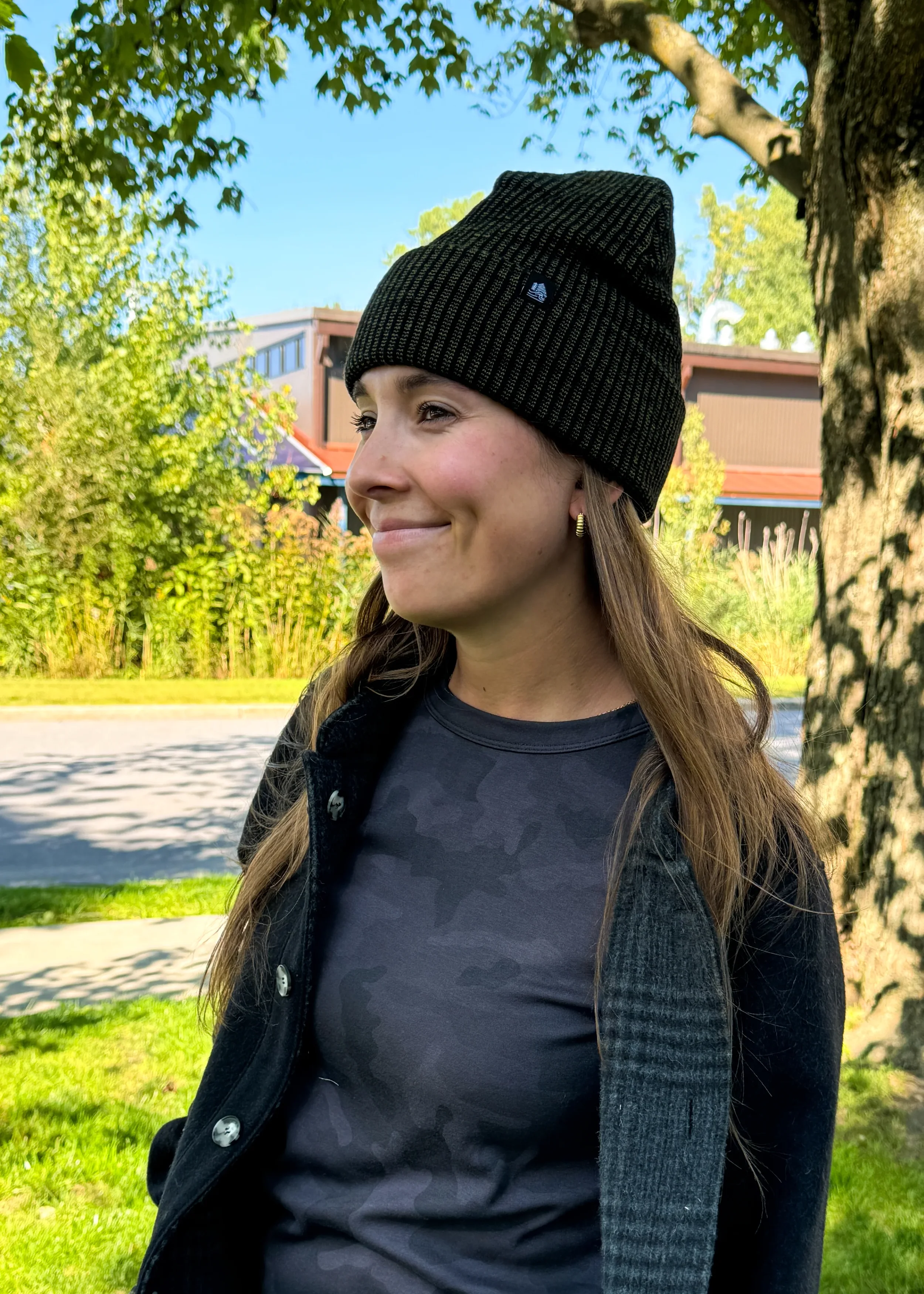 woman wearing a black 4t2d beanie made by fourbital factory on a fall morning in vermont
