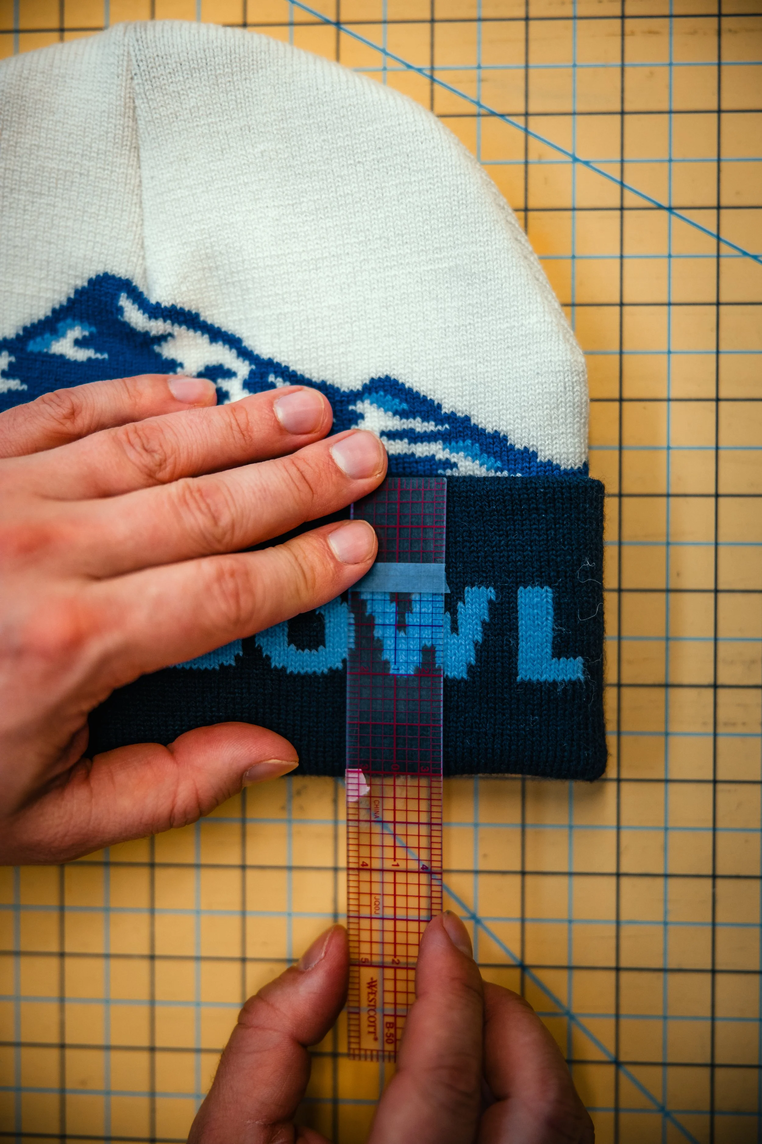 a beanie cuff being measured to ensure accuracy and quality