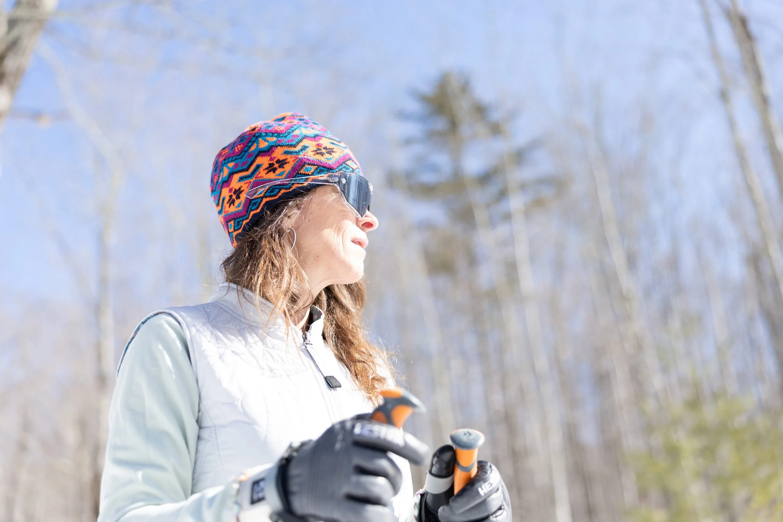 woman wearing a jacquard beanie from fourbital factory while cross country skiing