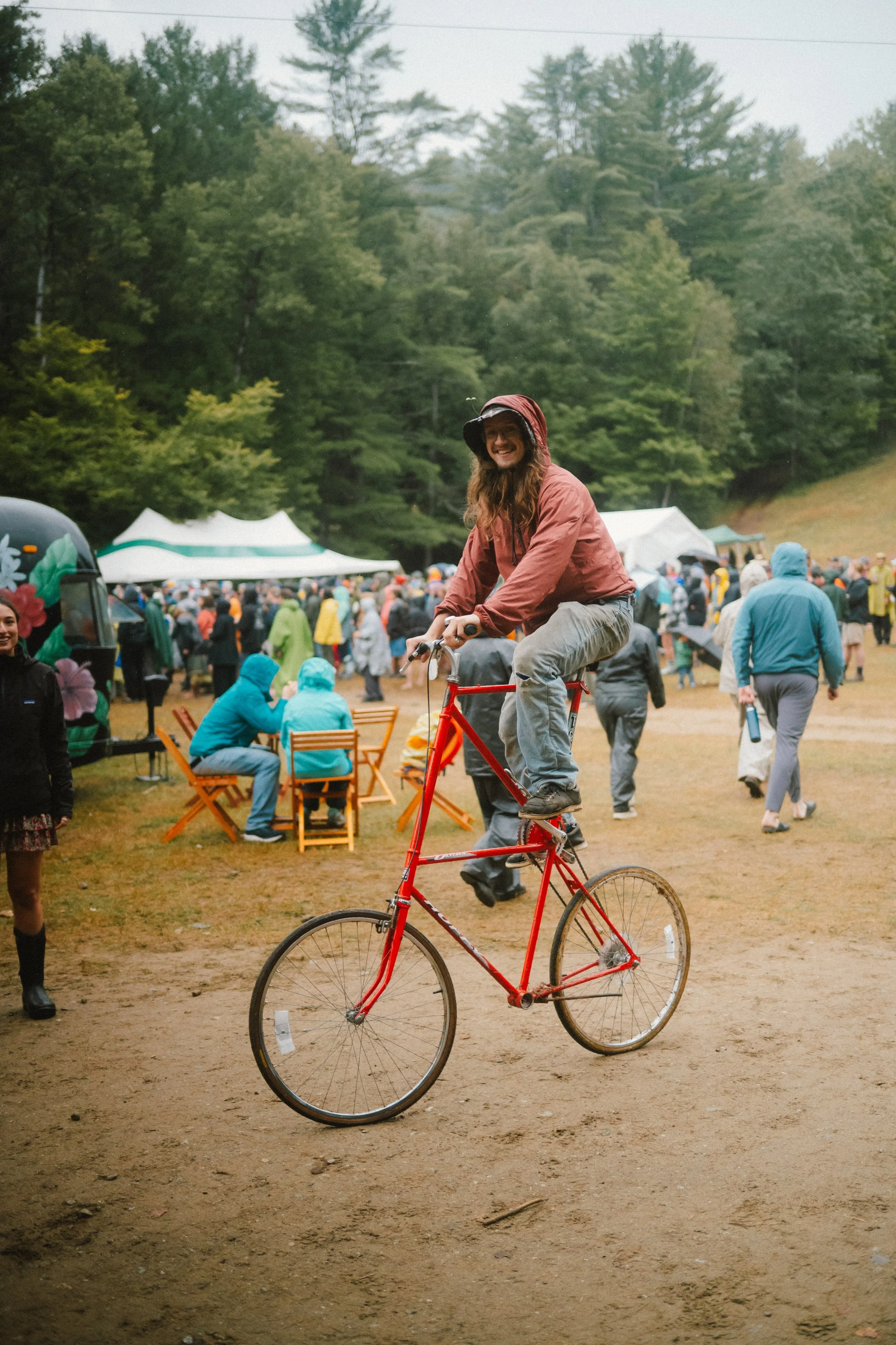 man riding a tall bike at otis mountain get down music festival