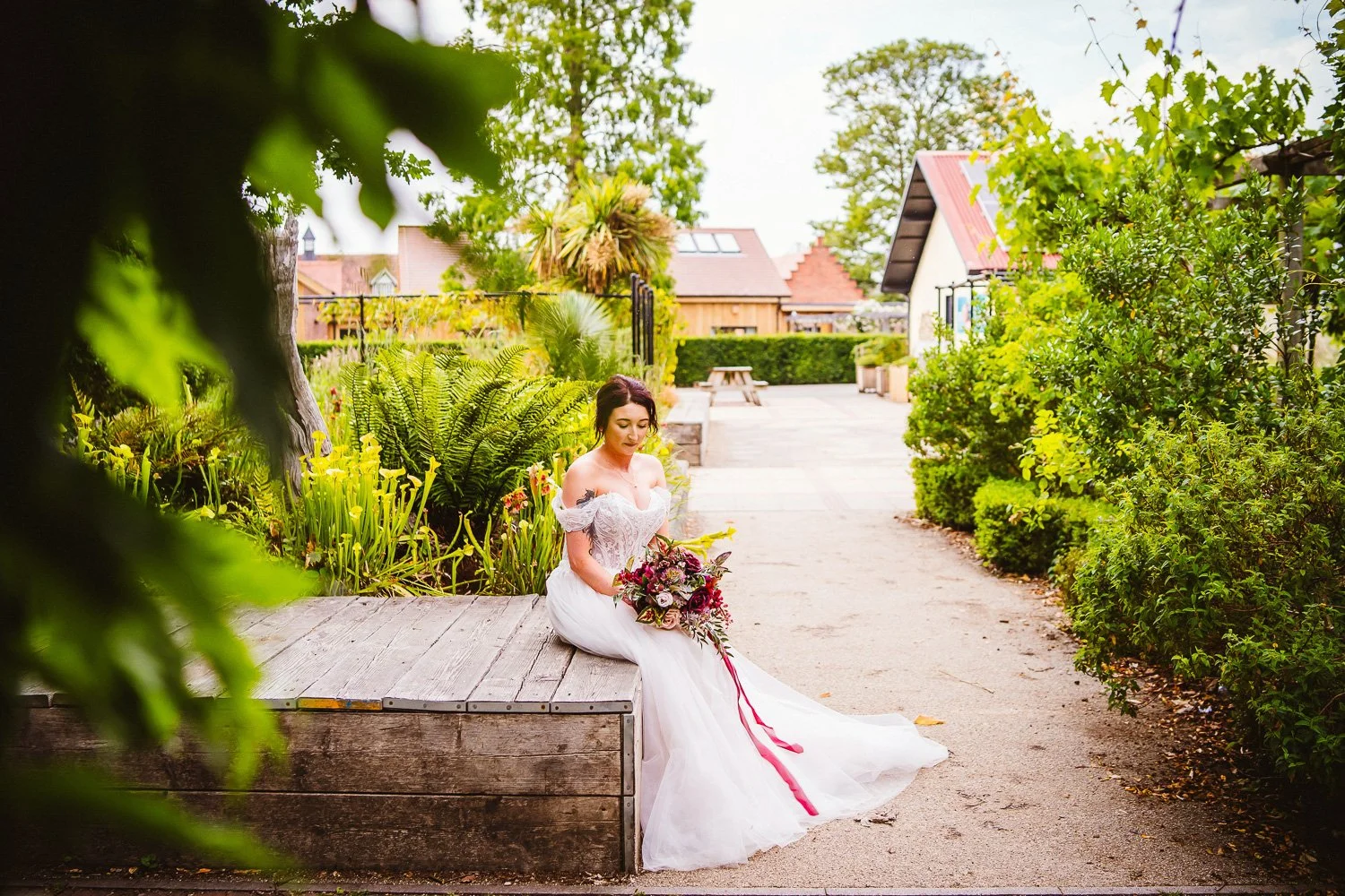 Textured faux wedding bouquet blending peonies, roses and tulips with dark greenery.
