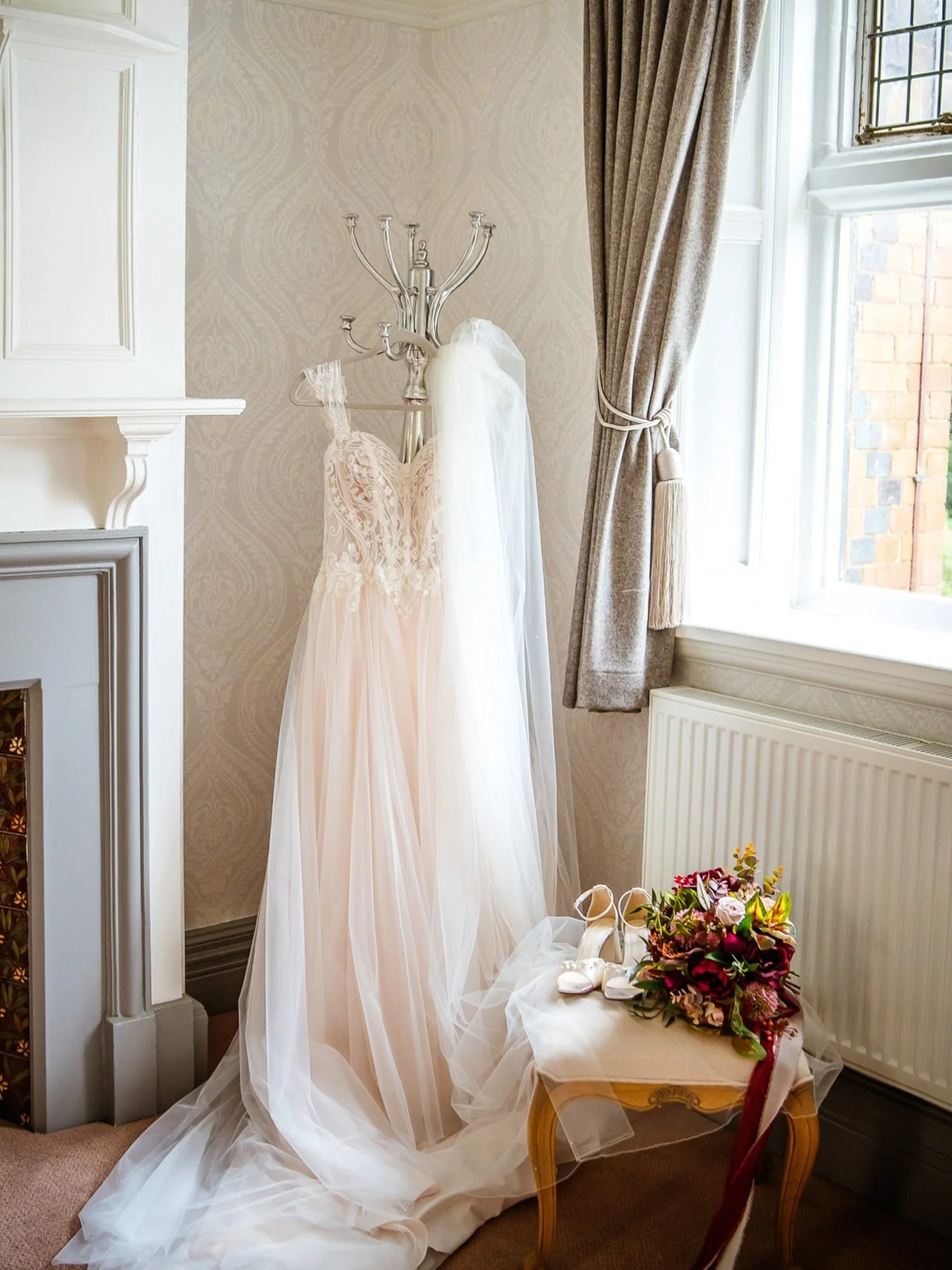 A full moment for this set-up 🤍

Kirsty&rsquo;s stunning dress from Susan Craig Bridal, Chorley hanging perfectly, the veil catching the light, and those rich burgundy tones adding warmth and depth to the space.

This is why I love detail shots so m