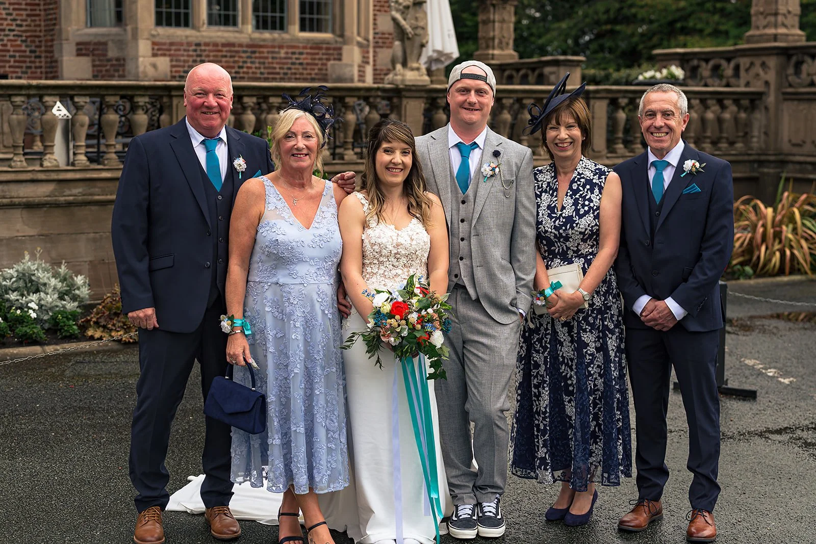 Emma, Tom and family at their teal wedding at Crewe Hall