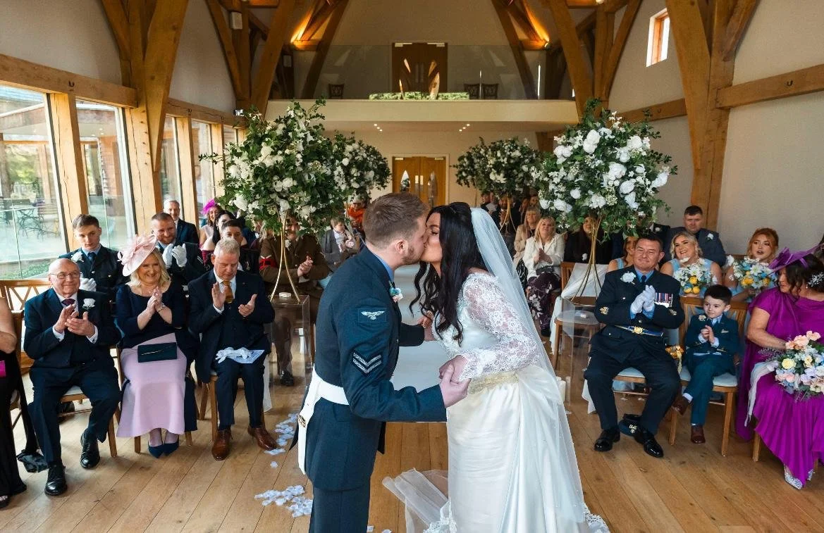 Groom buttonhole created with silk wedding flowers in soft pastel tones to complement the bridal bouquet.