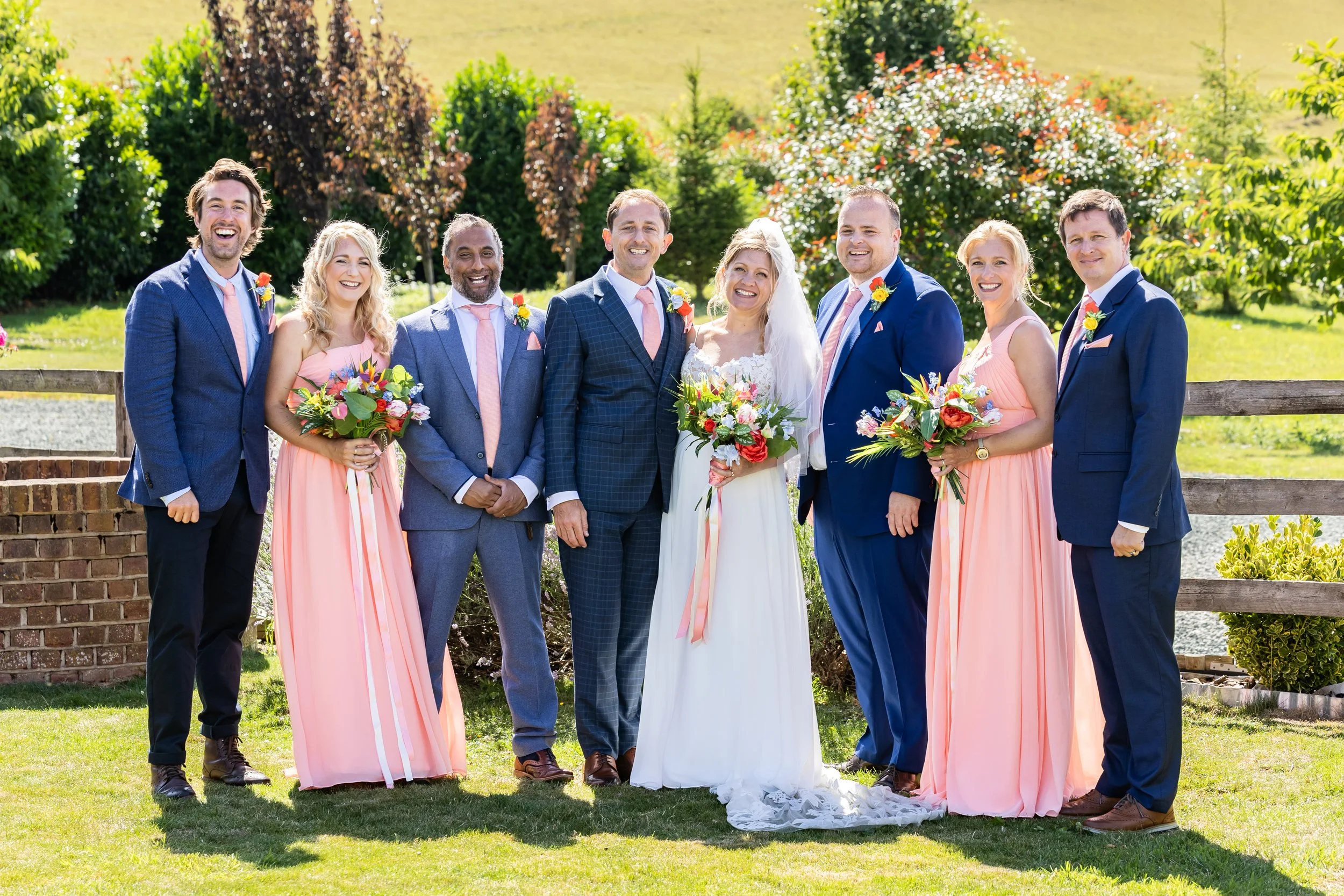 Anna’s bridal bouquet blending English garden flowers with tropical elements including orchids and coral tones.