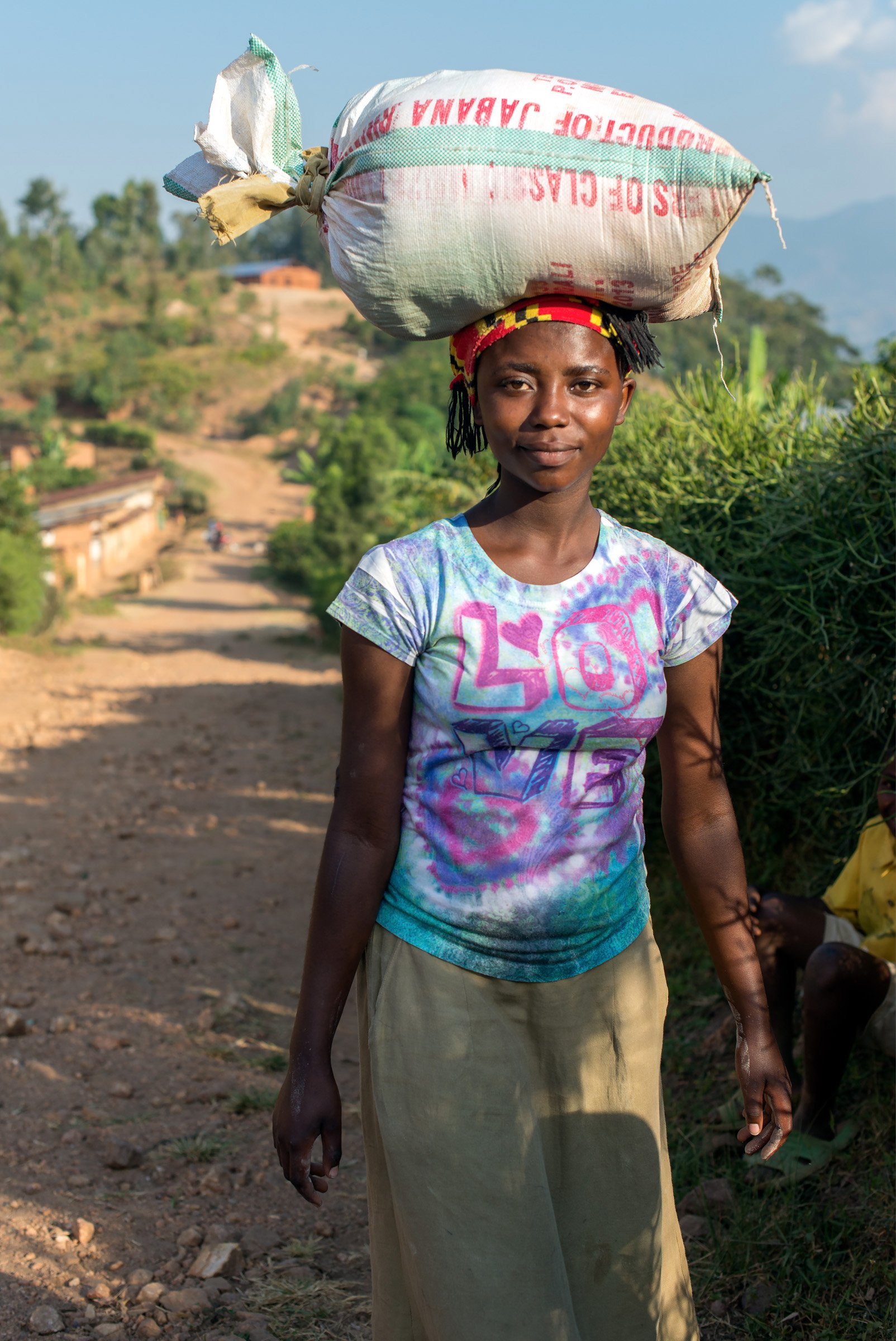 Woman carrying coffee on the road to Kigarama -Bamberger