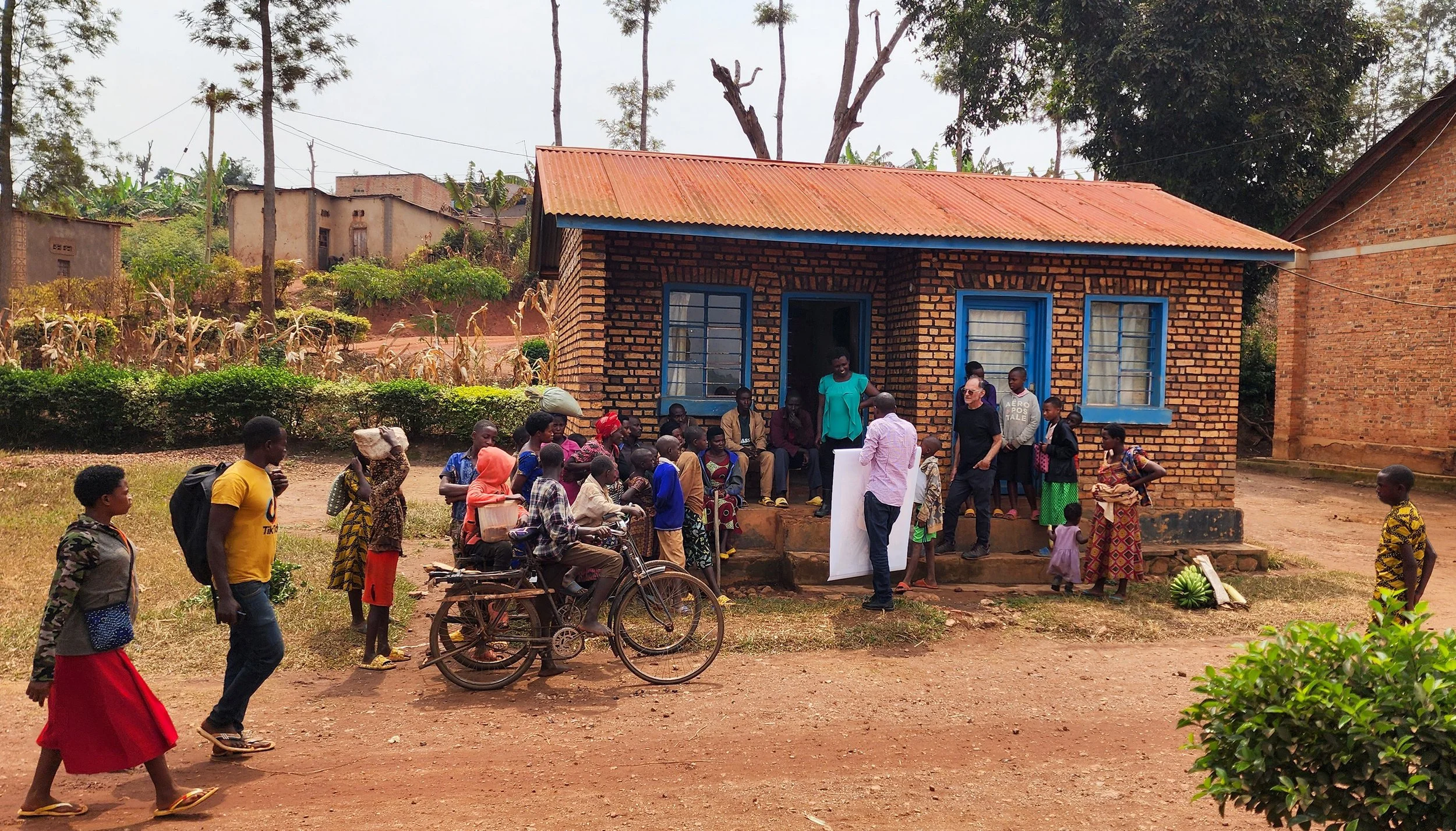 Faustin shares Bamberger's 2018 portrait of Cyambari with a family in Rwanagana as we begin the process of trying to locate him.