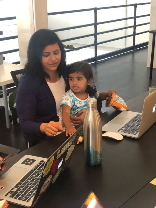 Anu with her daughter Mila at the office.