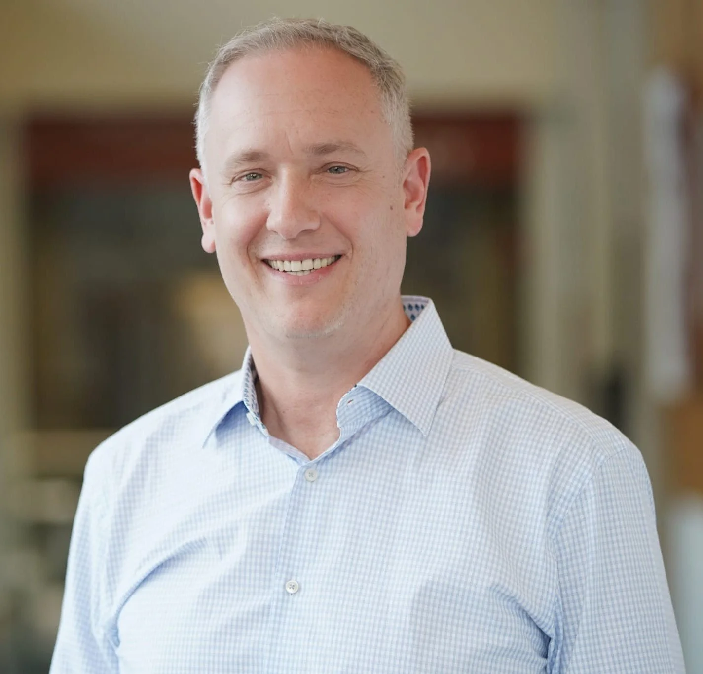 Sean Fogler, MD, smiling, in a light blue collared shirt