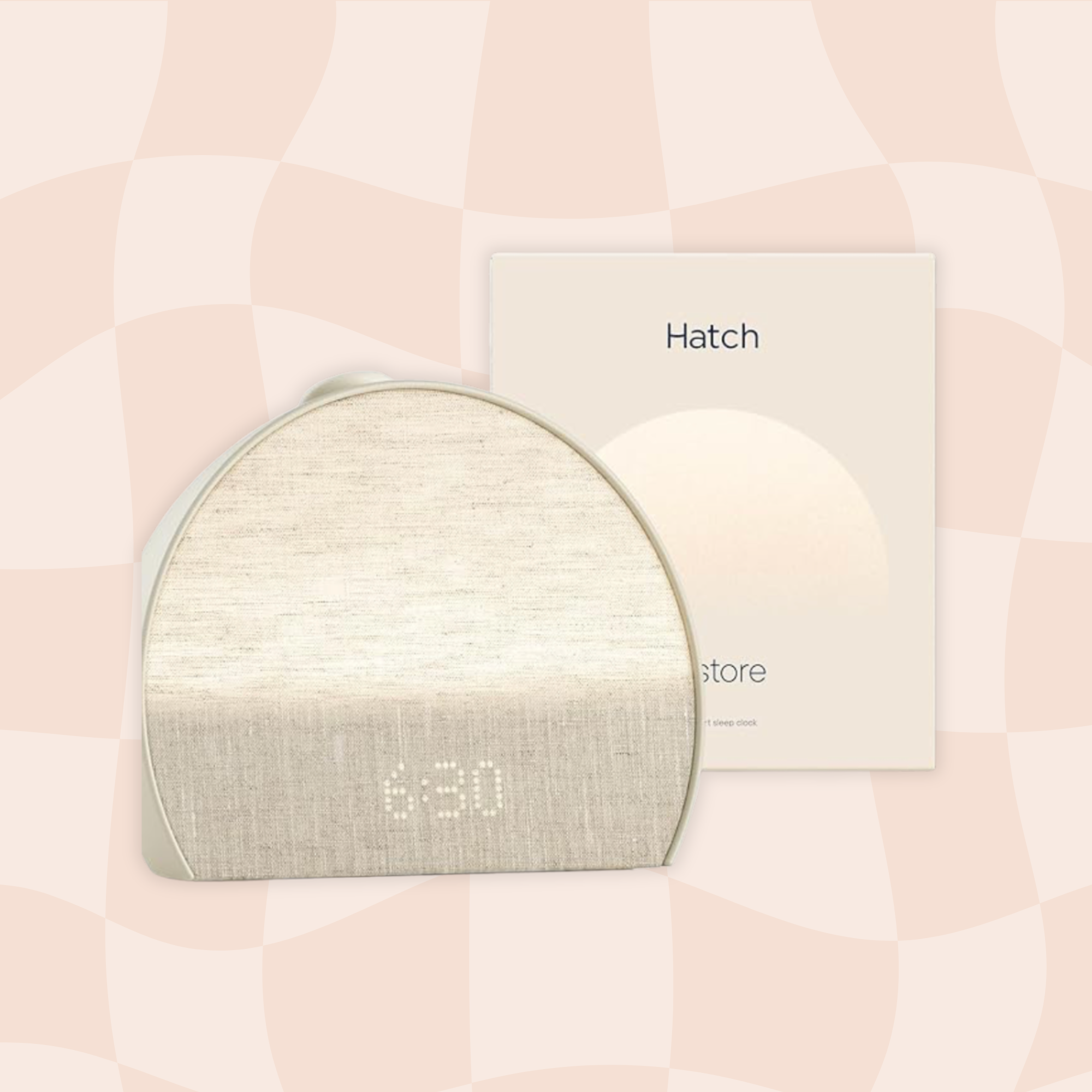 A close-up view of a beige fabric sleep mask with a white border, resting on a light-colored surface. In the background, there is a partially visible label or box with the word 'Hatch' printed on it.