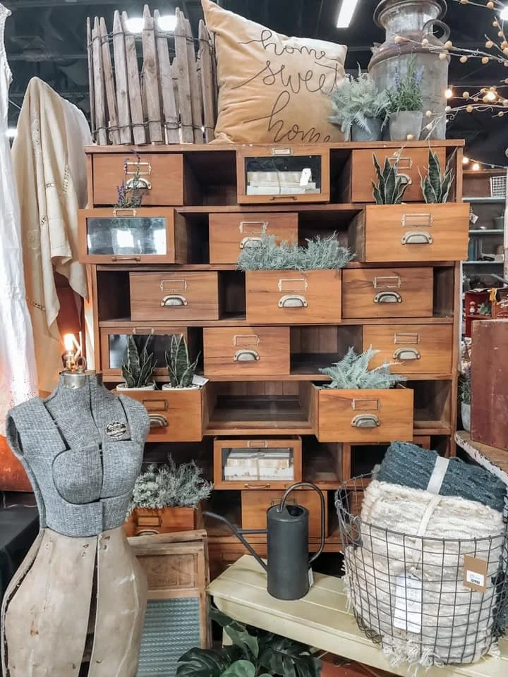 A 'Home sweet home' throw pillow on top of a wodden shelf.