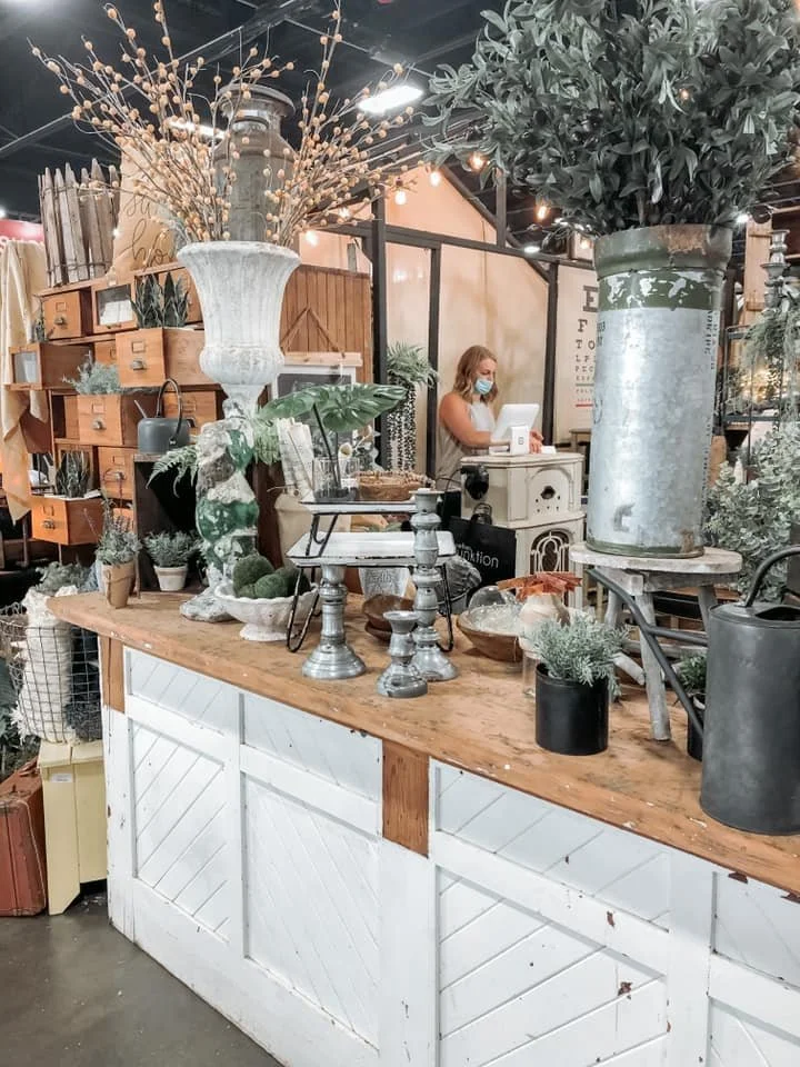 Decorative greenery and vintage candlestick holders.