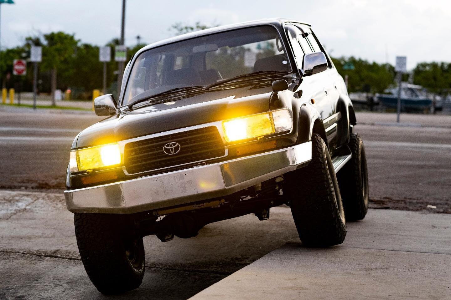 Sitting on new Dobinsons suspension with 2-3 inch lift, custom front bumper, a Ganador exhaust system, black Mickey Thompson Classic III wheels, new 35 inch BFGoodrich KO2 tires, fender-mounted mirror, mud flaps. and aluminum Toyota side steps.