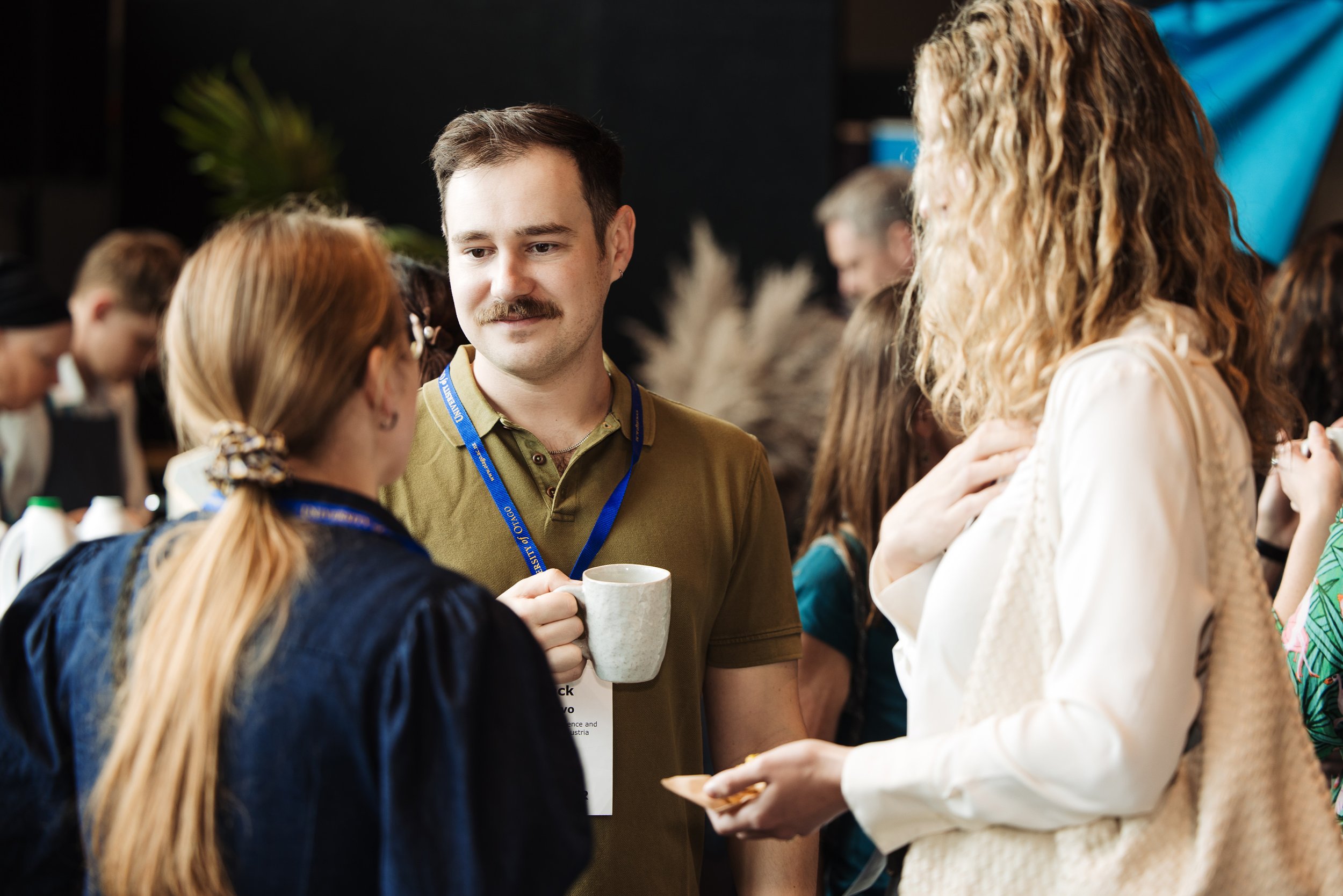 Conference delegates networking during a refreshment break, creating opportunities for connection as part of the delegate experience.
