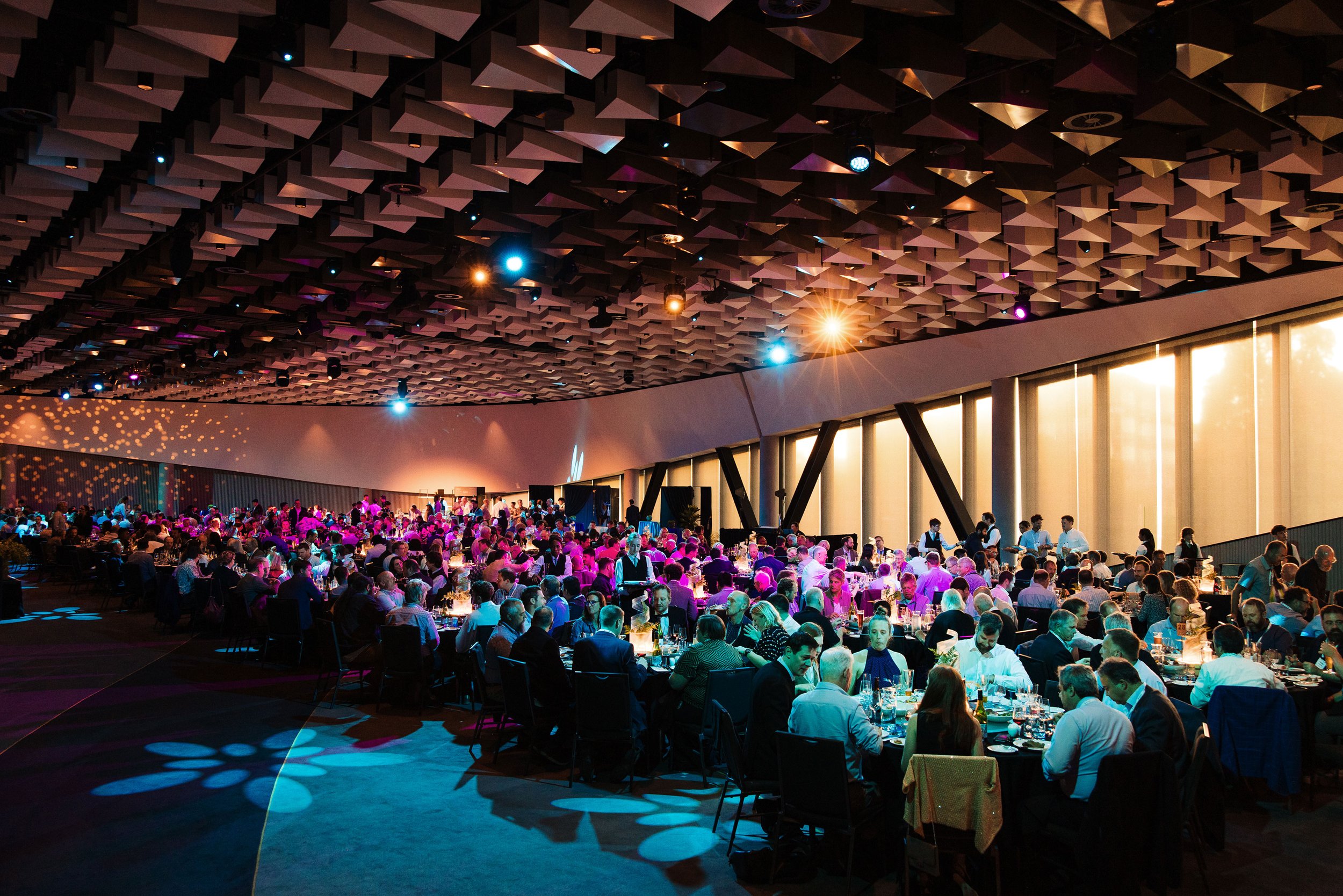 Large conference dinner showcasing professional conference social function planning and event management in New Zealand. Rivers Room at Te Pae Christchurch Convention Centre.