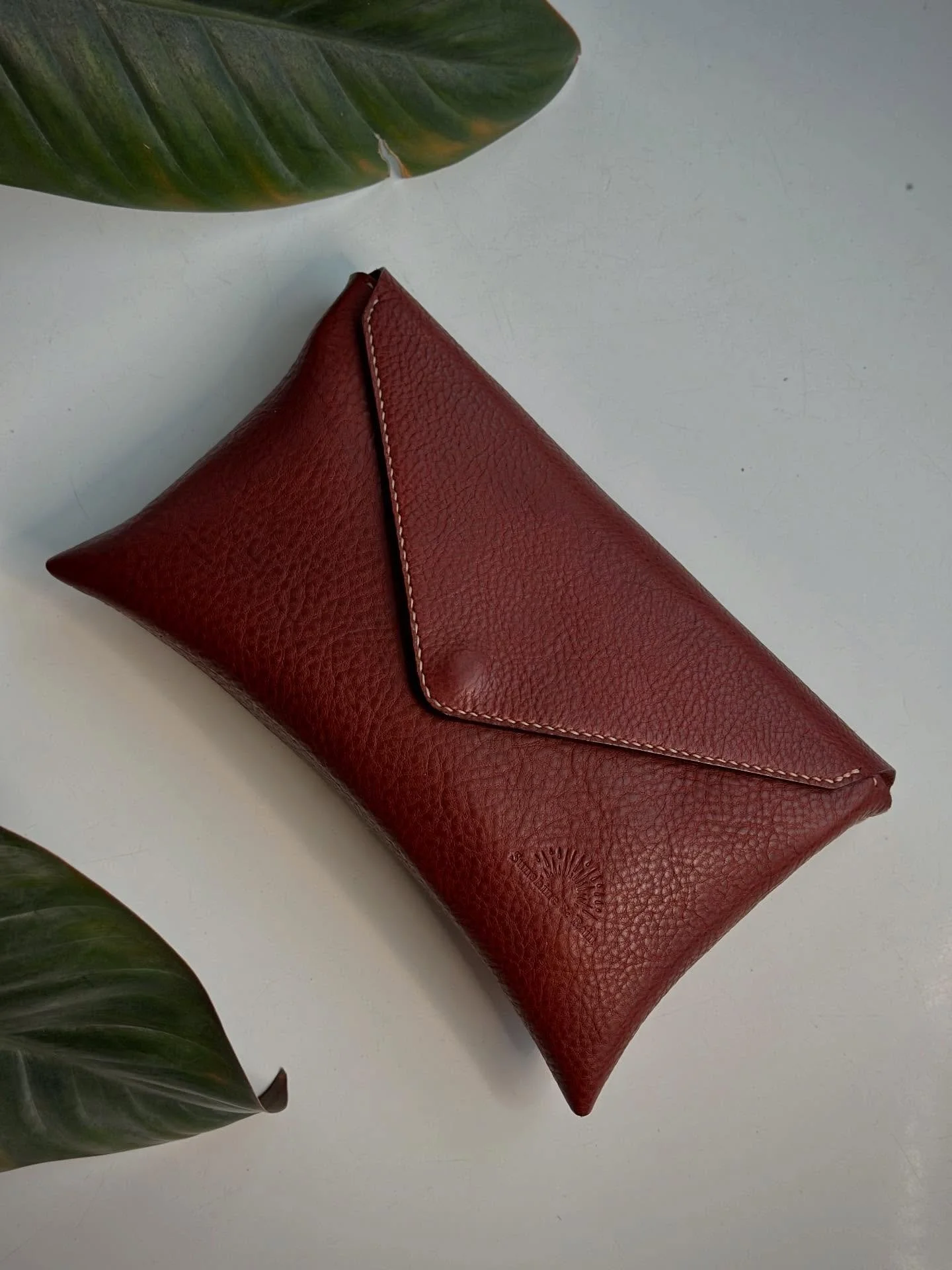 Last custom order for the year, and such a beauty! ✨

Classy Envelope Clutch is hand-stitched in Minerva Box in Dark Red.  Edges are stained and burnished.
This design is one of my first patterns.  I&rsquo;m thinking I need to make another.

Meanwhil