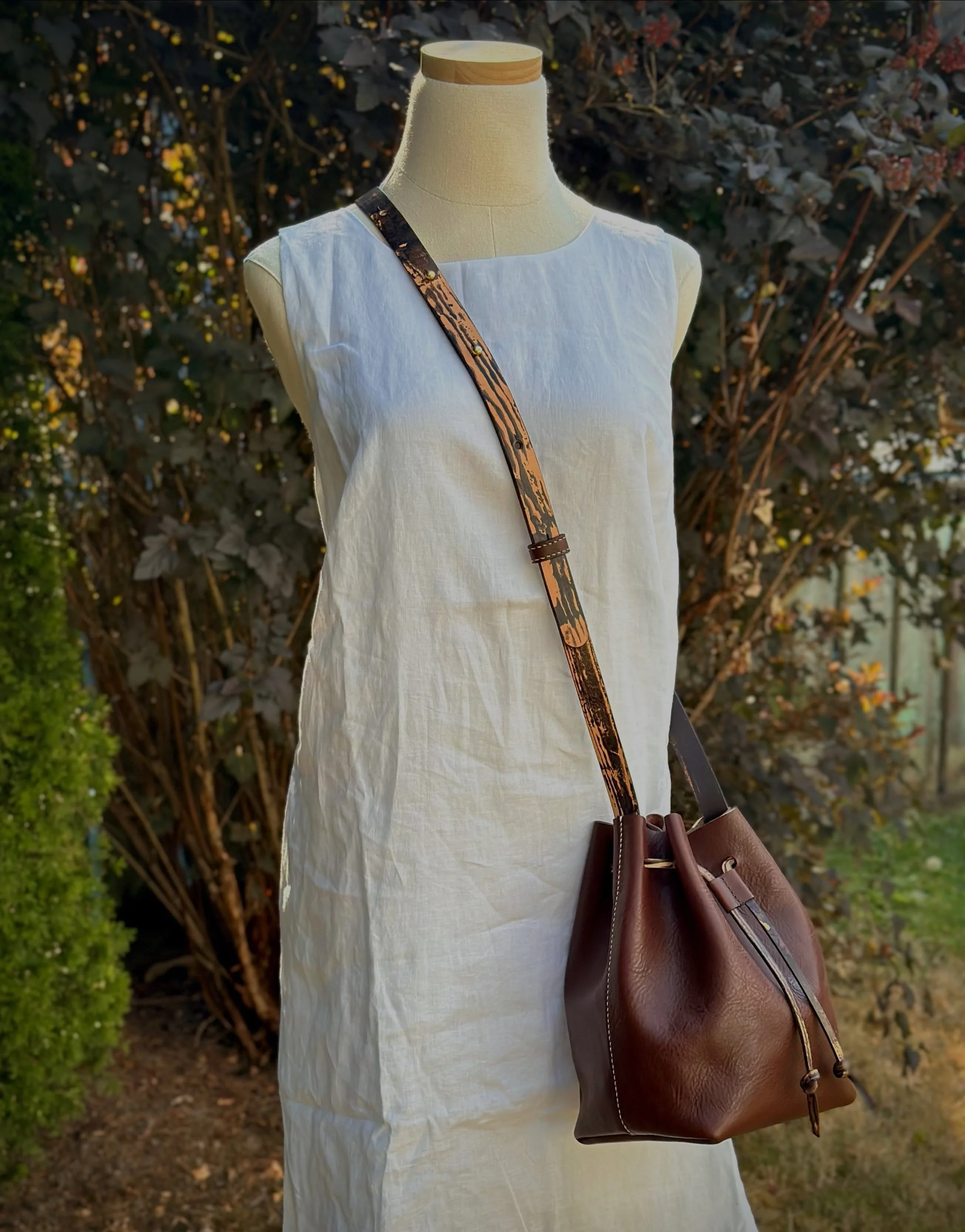 Absolutely in love with this one for the textures, color and shape.  A classic Bucket Bag has a wood grain pattern on the strap and cinch tie.  Hand-stitched using pebbled Minerva Box in dark brown that feels and smells amazing. 🪡

I&rsquo;ll be tak