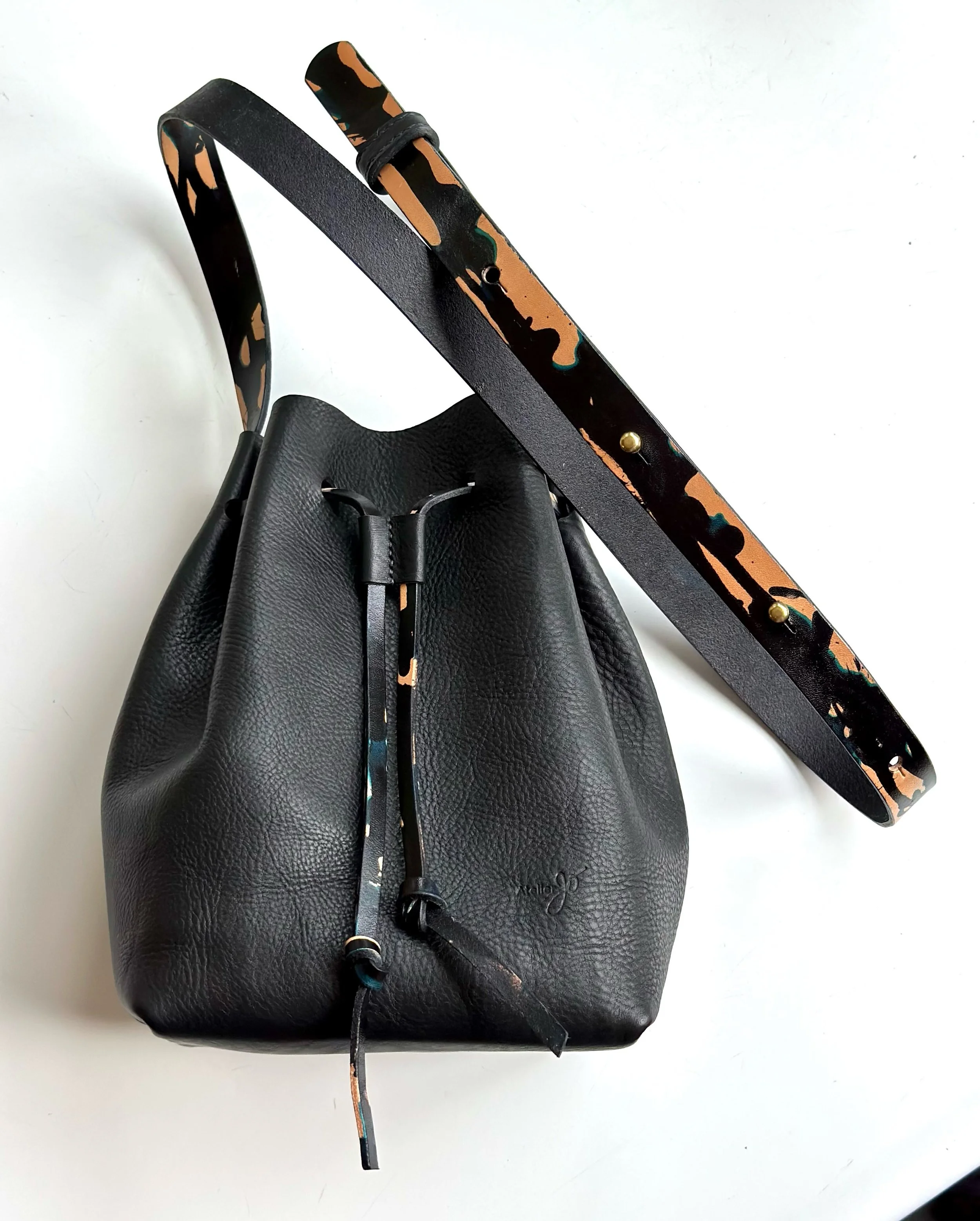 The strap took as much time to create as the bag, but who&rsquo;s counting time when you&rsquo;re in the flow. 😎. 
A beautiful Bucket Bag in black Minerva Box has a drip dyed strap and cinch cord with subtle echos of deep turquoise blue. 🦋. Saddle-