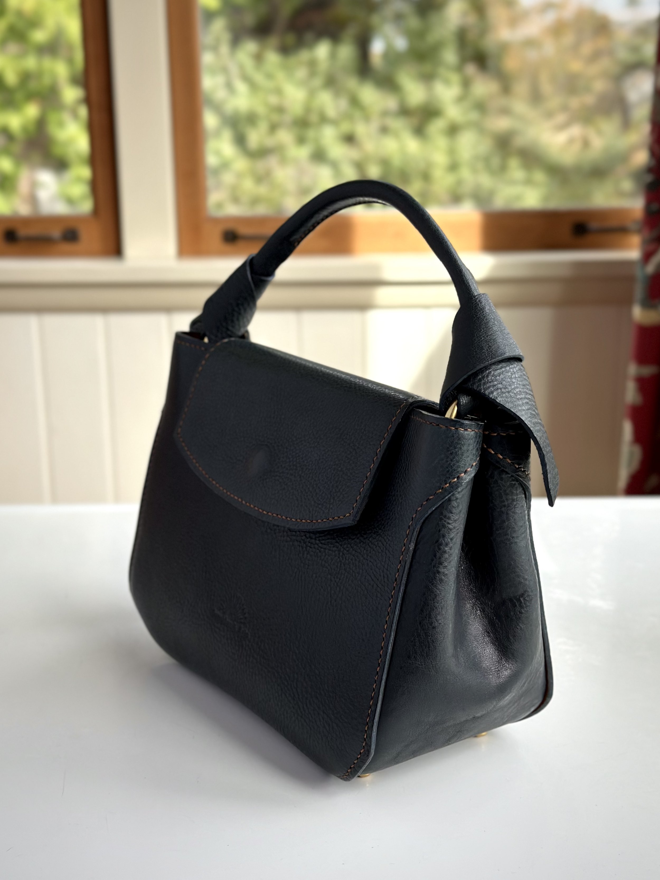 bluehandbagsideviewtwo.jpg