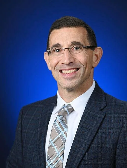 Stephen Fafulas headshot against blue background