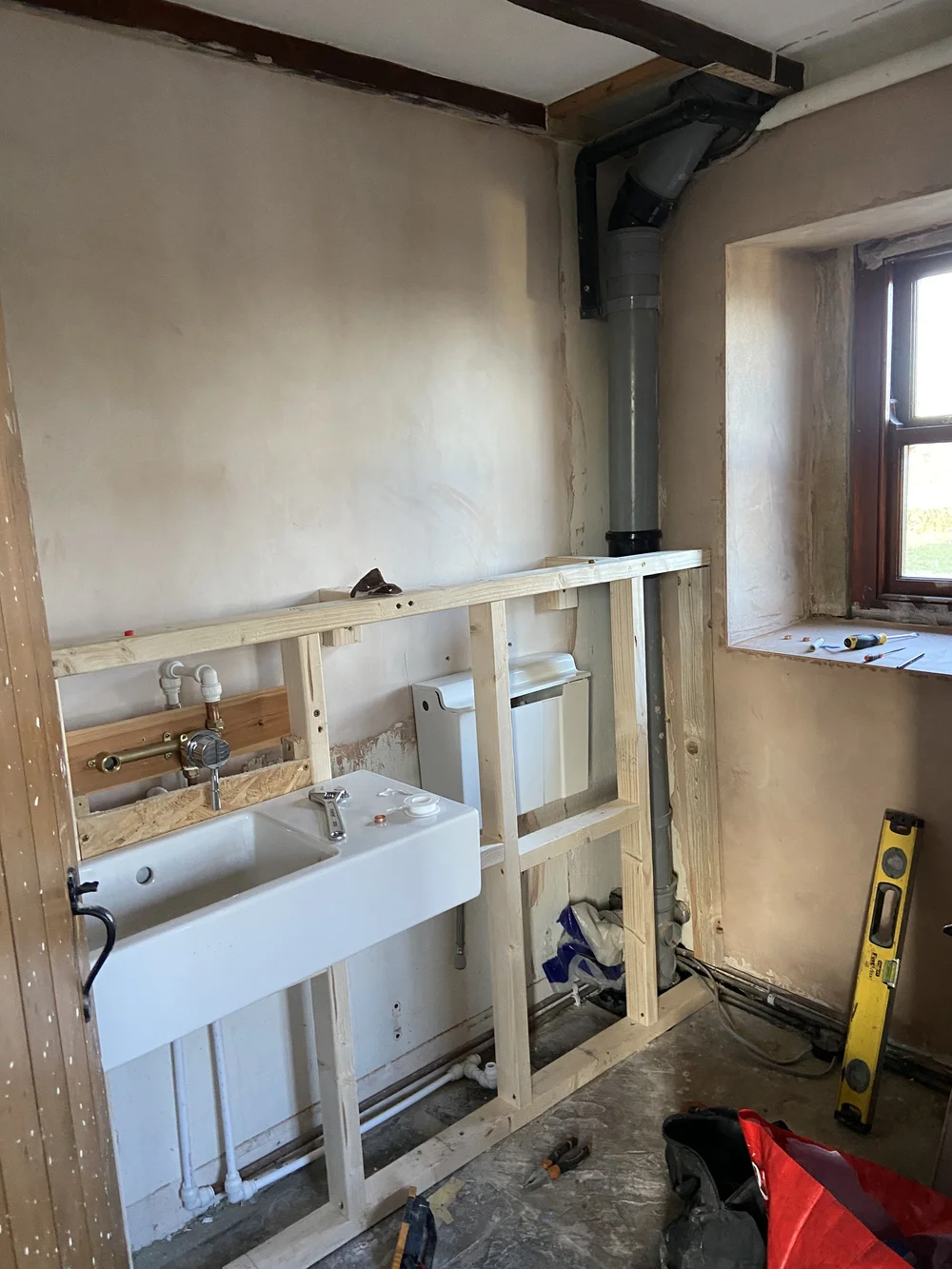 The false wall in place, sink hung
