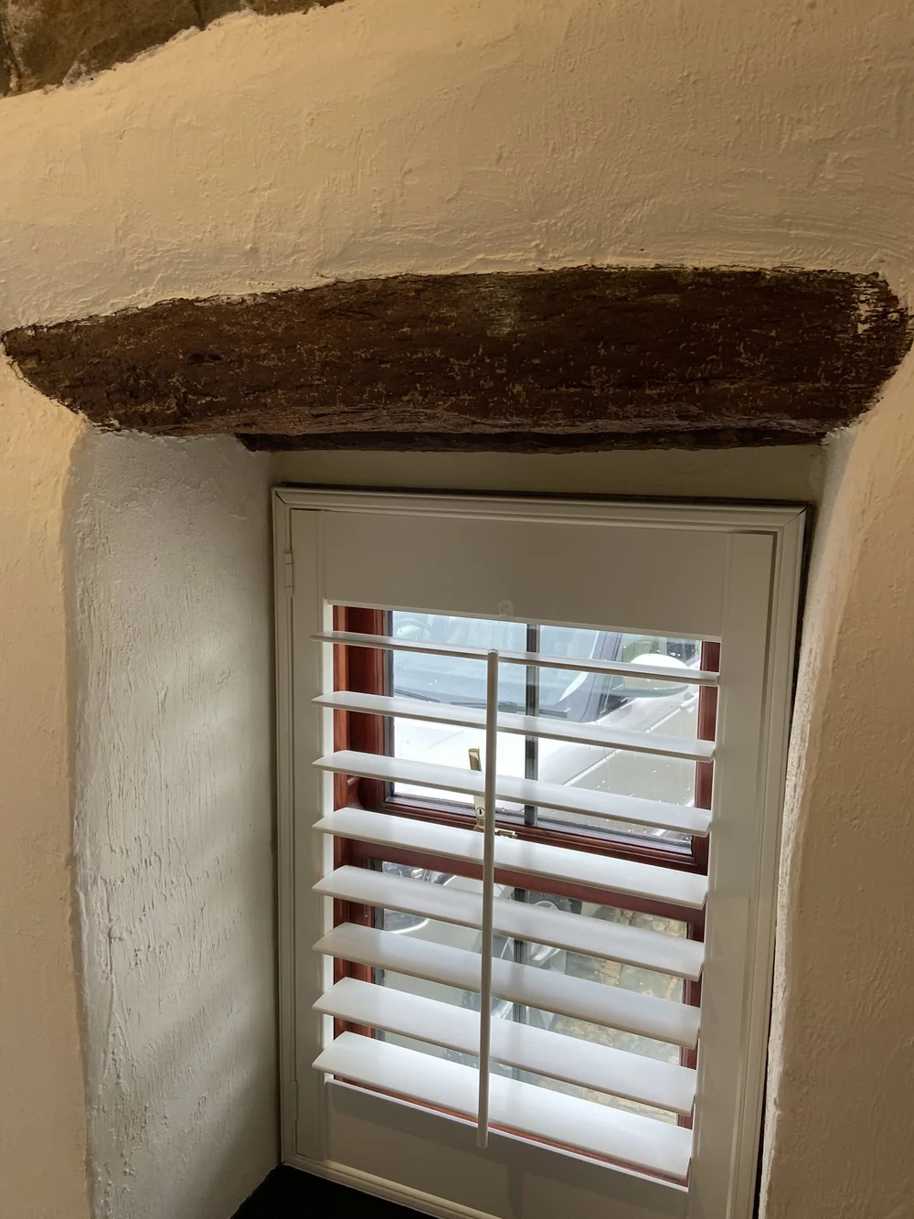 Thick framed plantation shutters on small windows blocked light