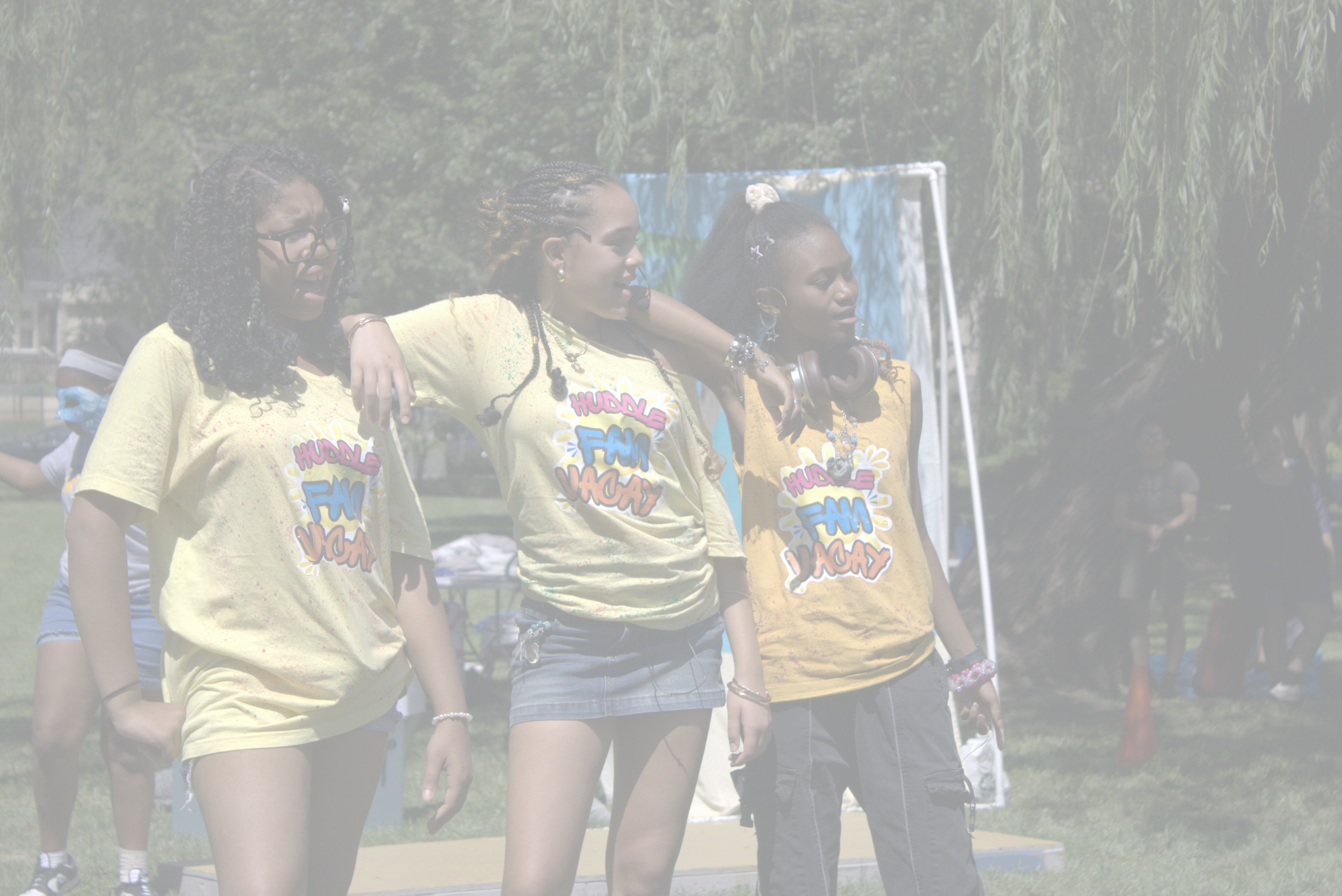 Group of children and teenagers standing outdoors in a line with arms around each other, possibly participating in a group activity or team-building event. | Yes! And Collaborative Arts