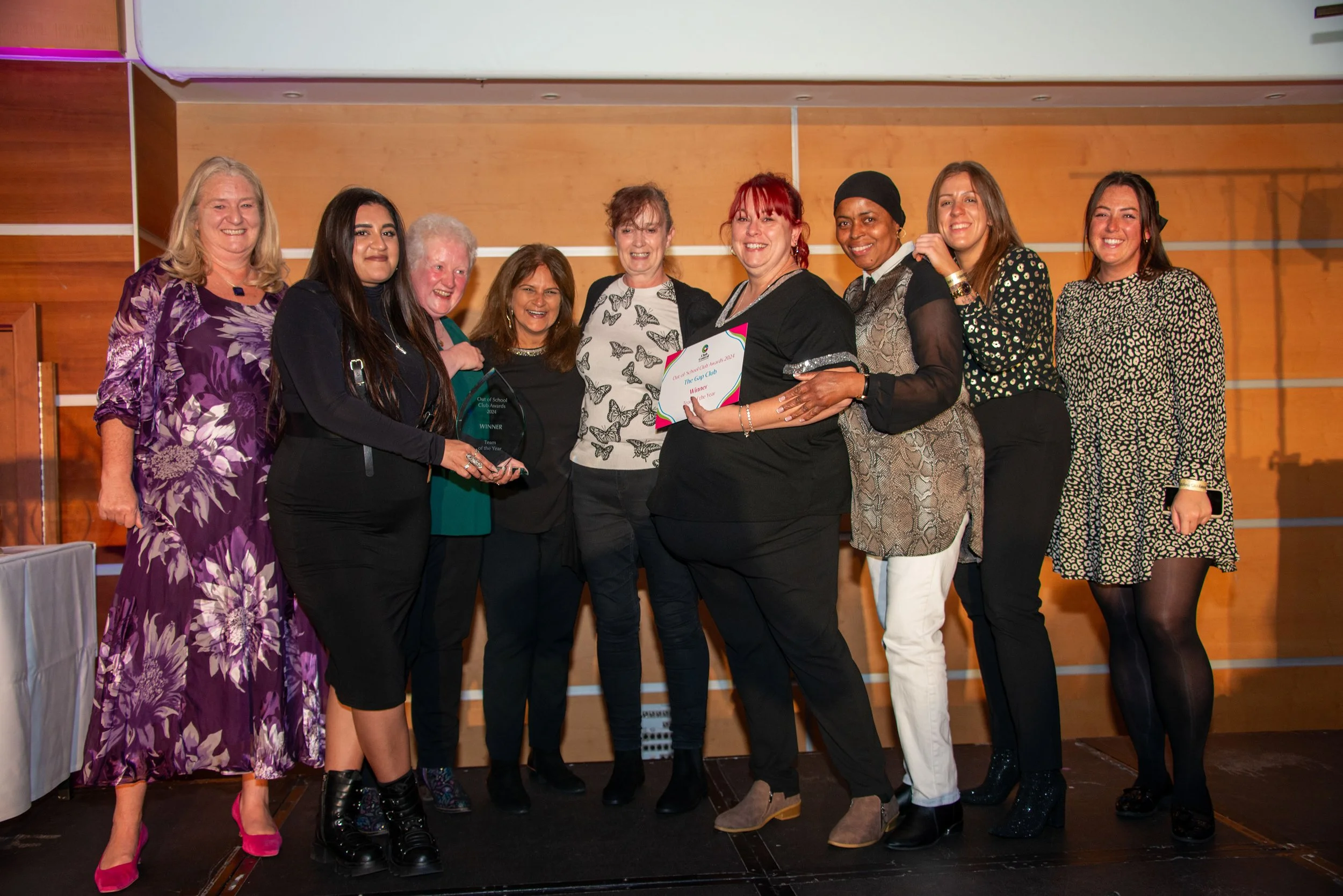 Group of 9 people on a stage