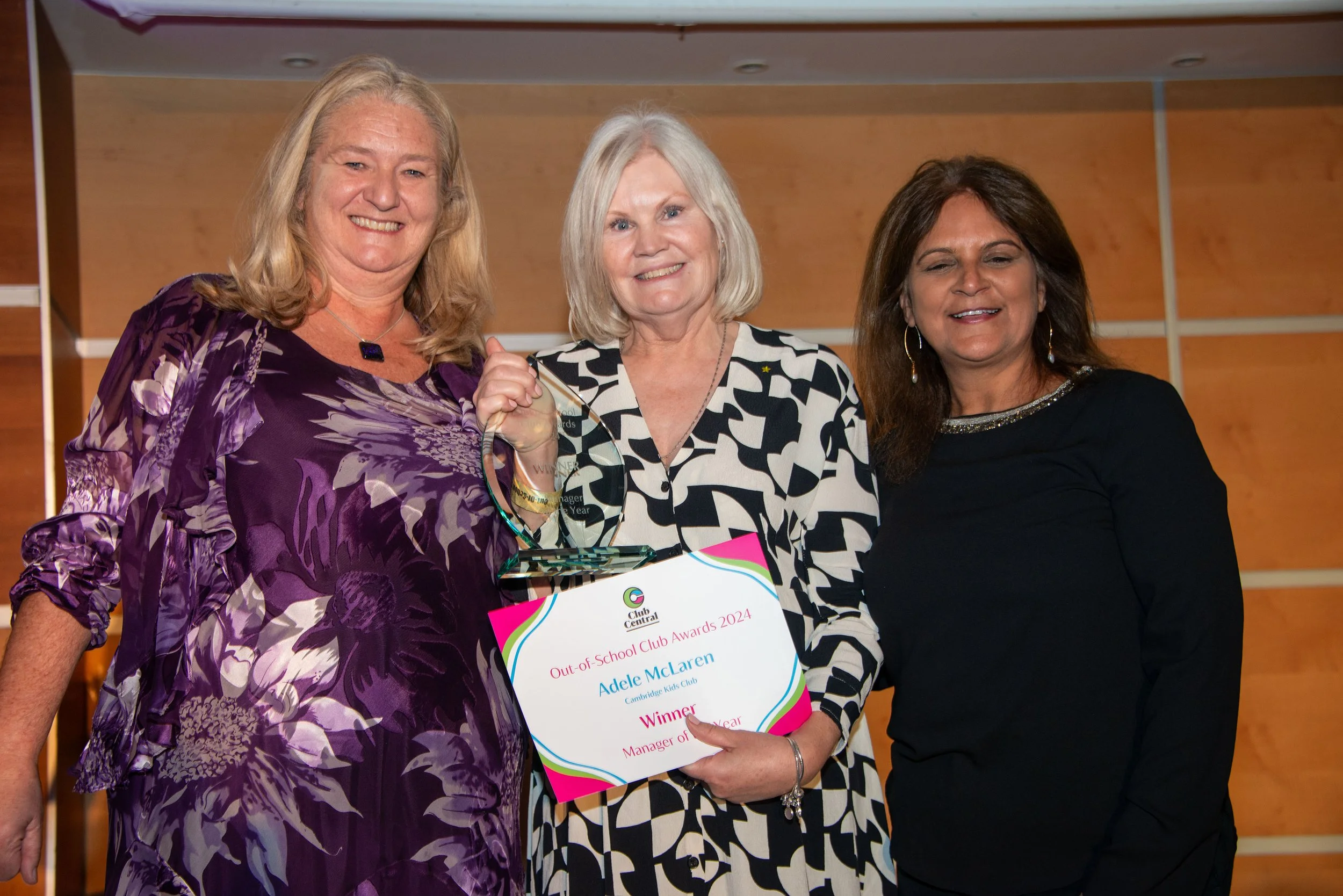 Three females smiling at the camera