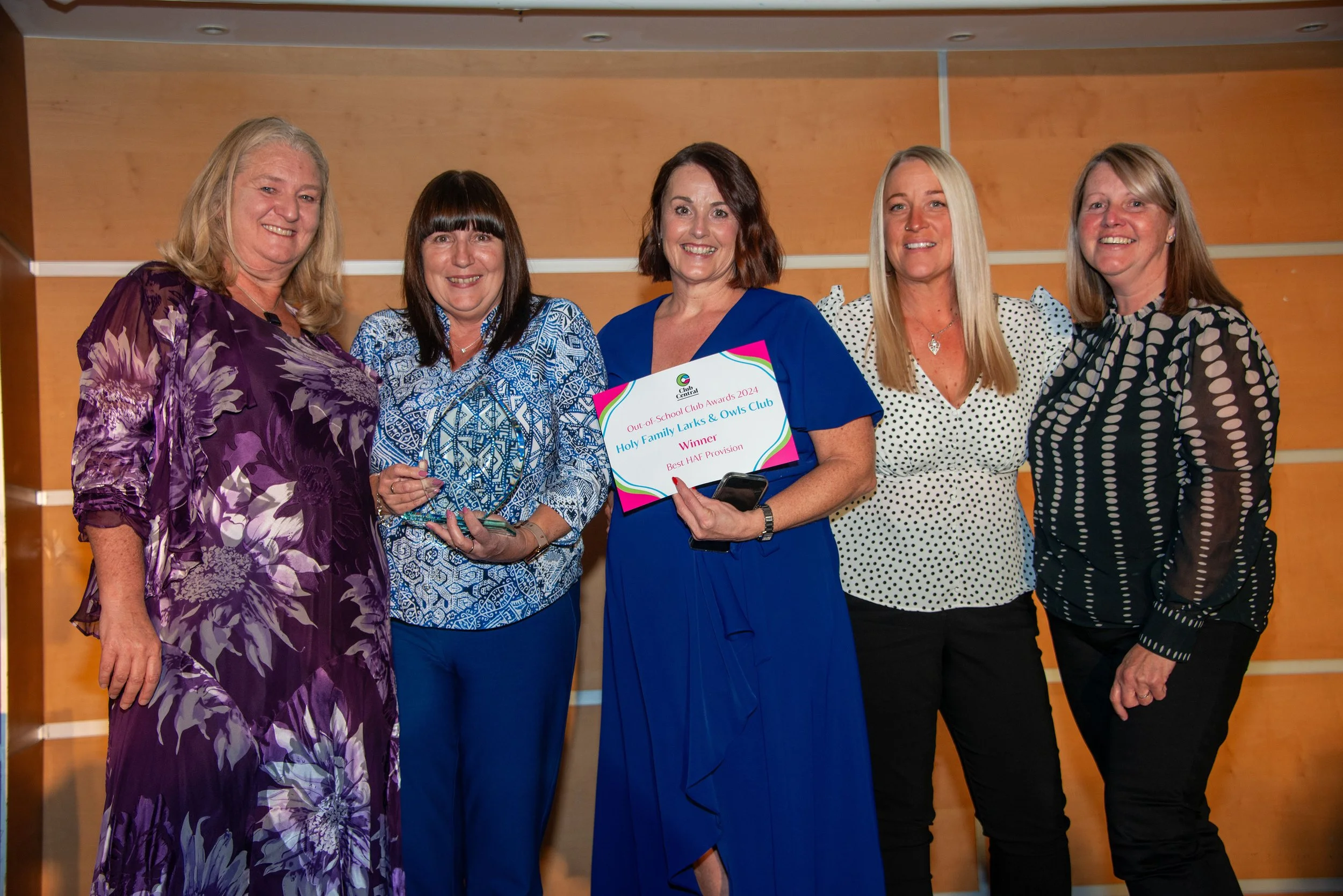 Group of 5 females looking at the camera and smiling