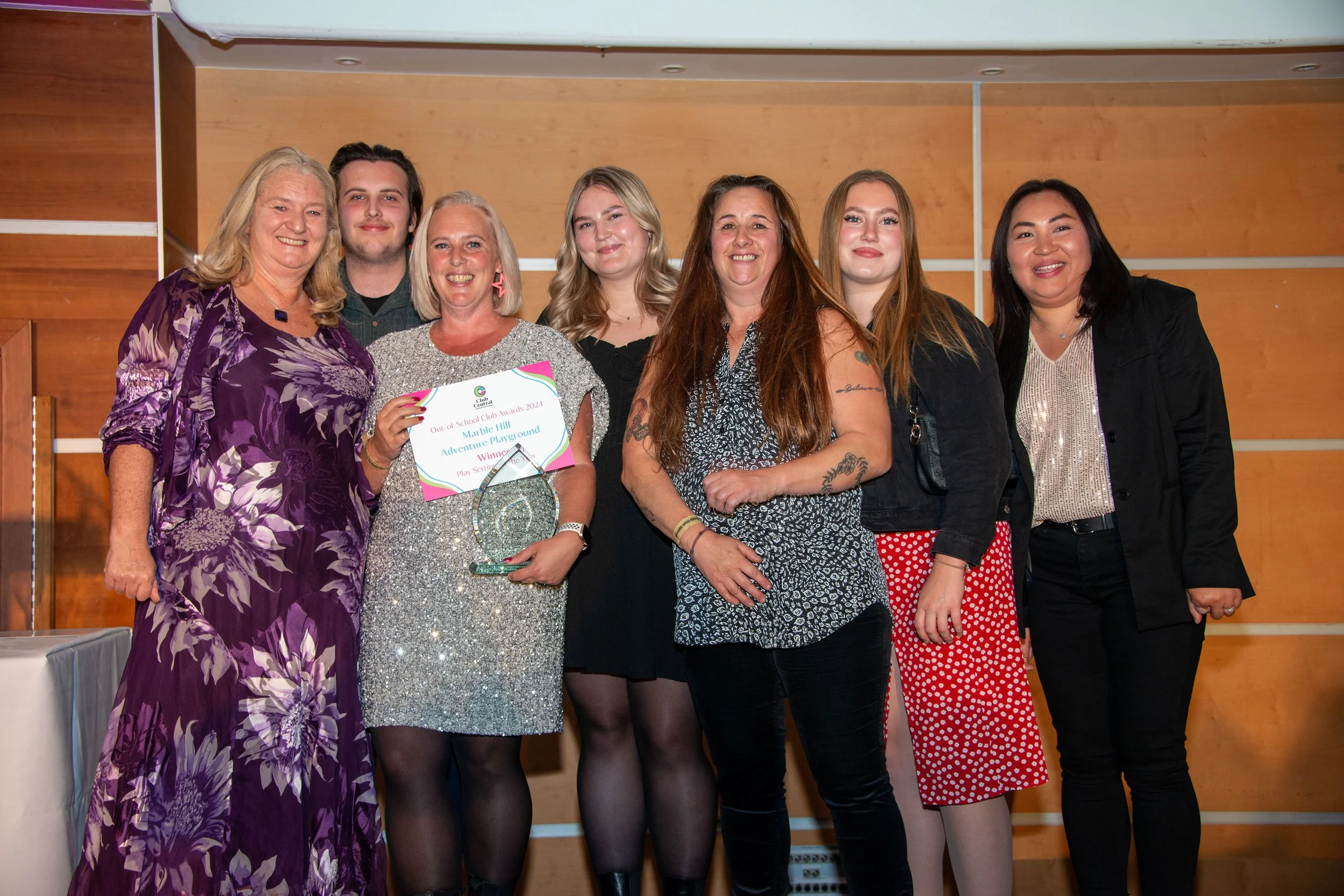 Group of  7 individuals smiling at the camera
