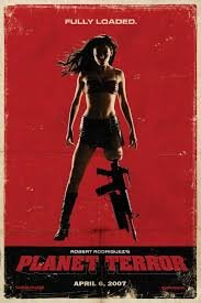Planet Terror poster with a woman standing and facing us, a machine gun for a left leg