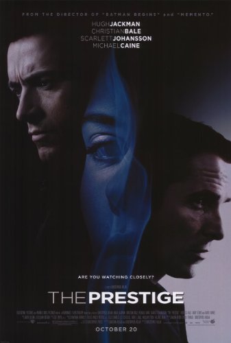 The Prestige poster with two men facing out and opposite of one another, the face of a woman in the middle looking at us.