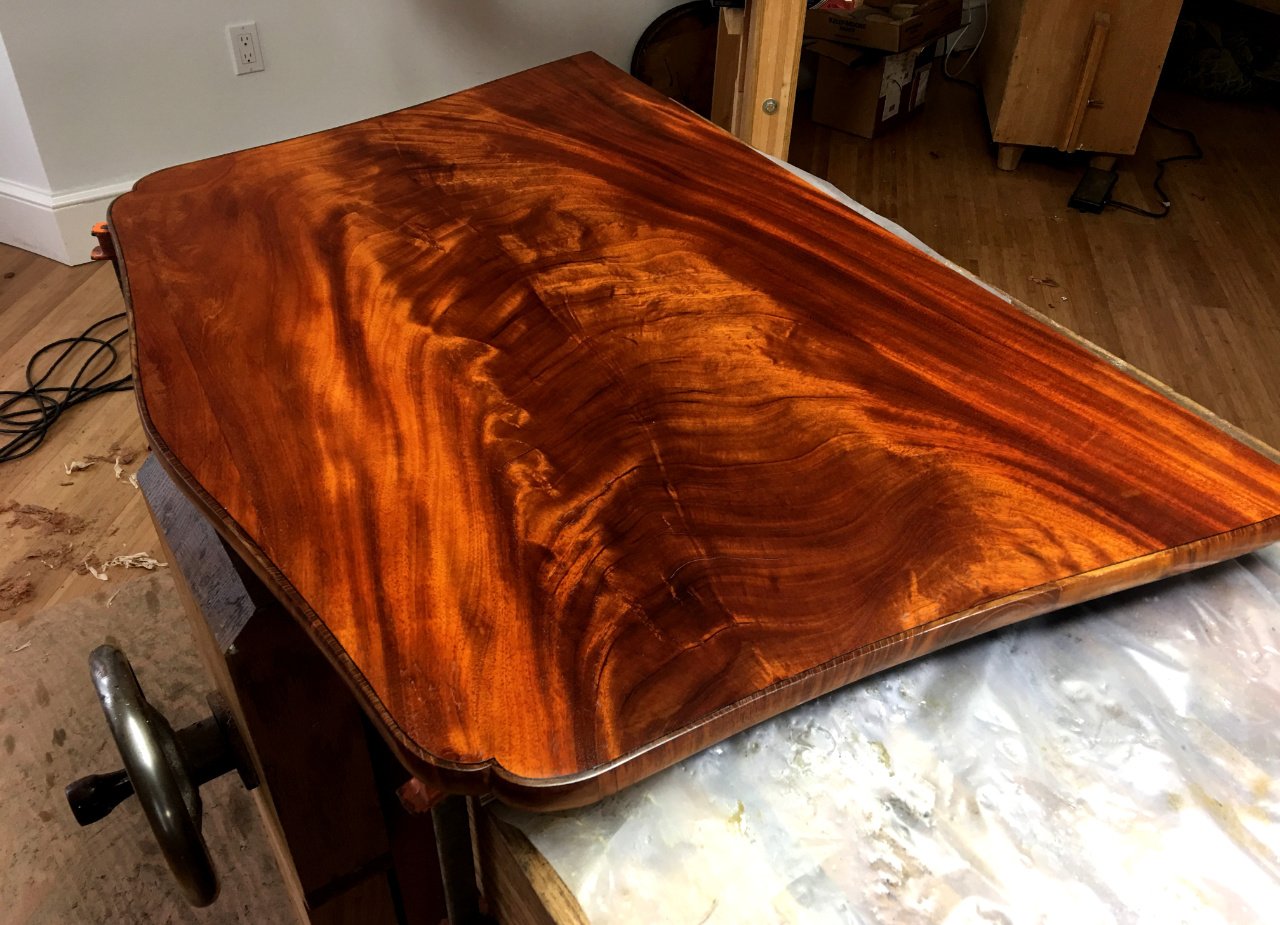 French Polishing a Mahogany drop leaf from a handmade reproduction of an antique table.