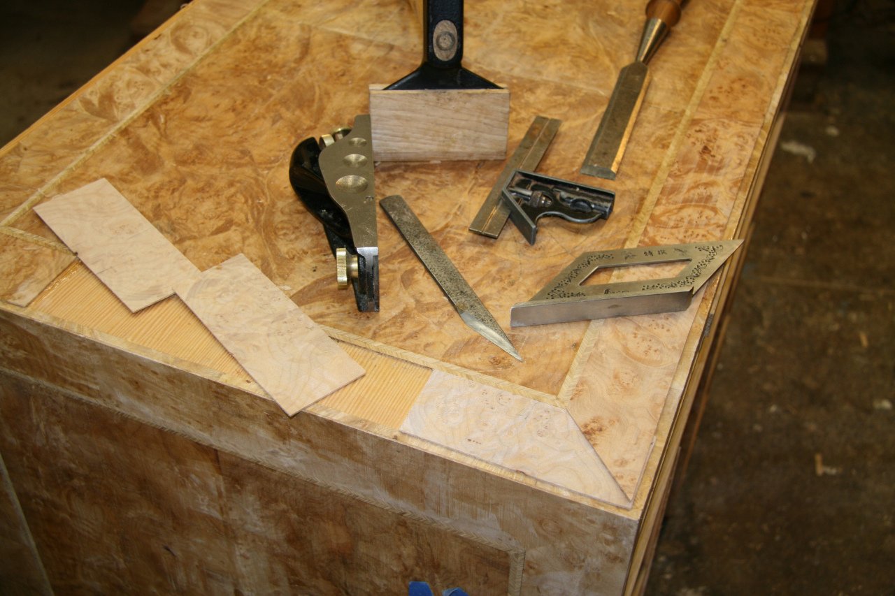 Traditional woodworking tools used to make a reproduction of an antique burl wood knee hole desk.
