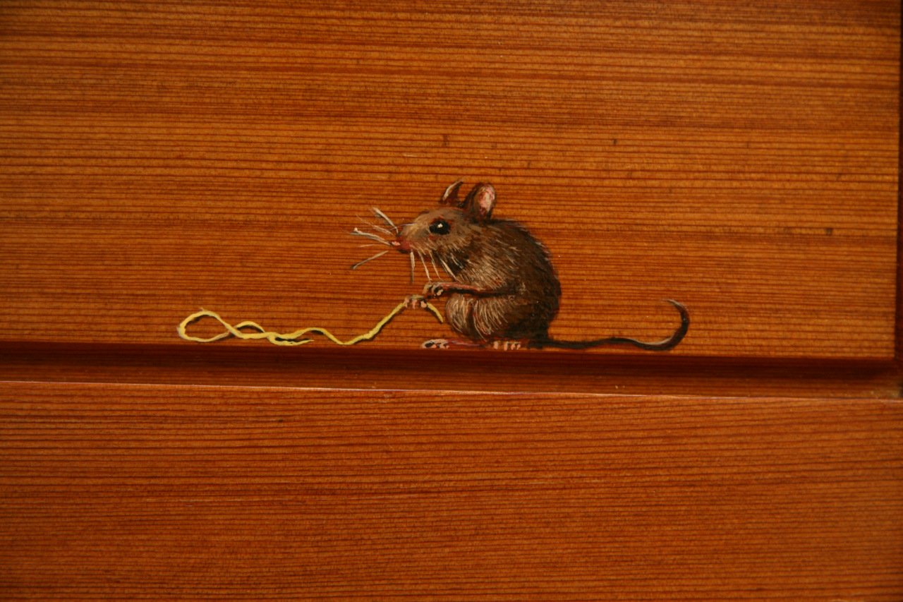 Painted mouse detail from a child's toy chest made from recycled redwood.