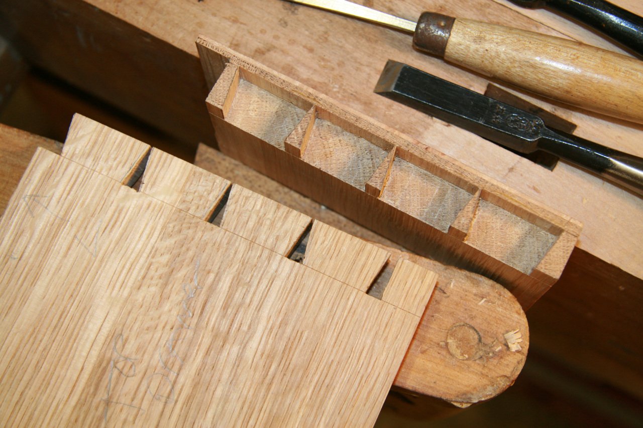 Handmade traditional dovetail joinery for a reproduction of an antique burl wood knee hole desk.