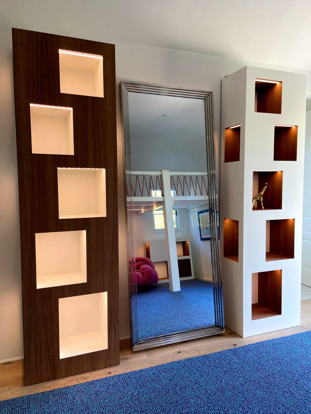 Modern custom design bookcase cabinetry featuring cubby holes that are LED lit, and can be used for the storage of books, artwork, or as simply open storage.