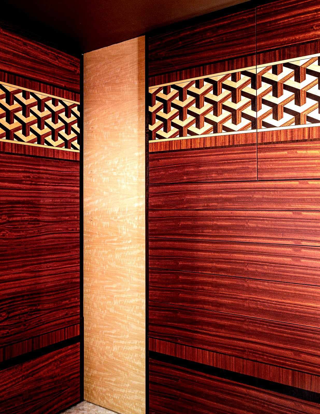 Custom built-in cabinet with wood parquetry design inspired by an M.C. Escher woodblock print.