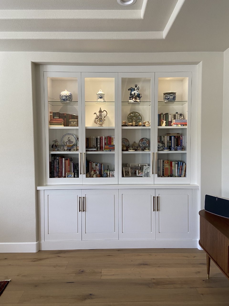 A modern custom built in bookcase with LED lighting for a family room.