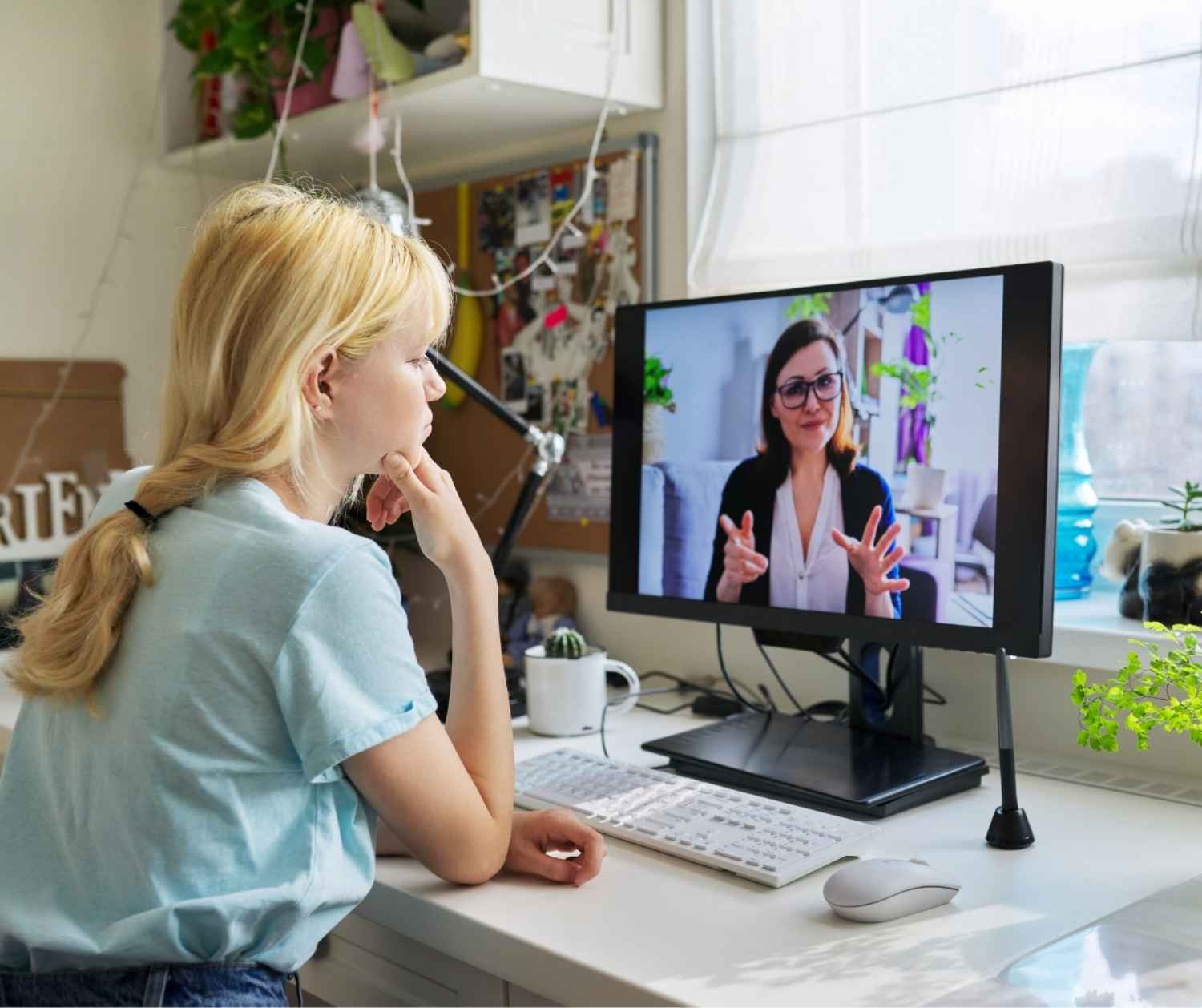 Teenage girl in an online speech therapy session at home