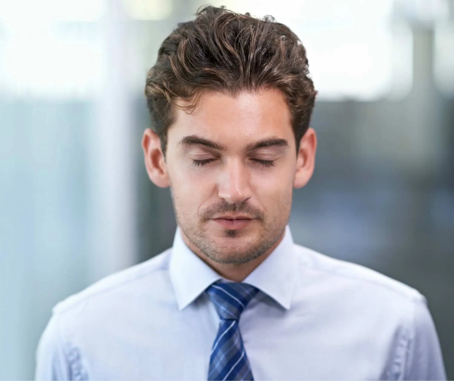 Man taking a calm breath before giving a presentation