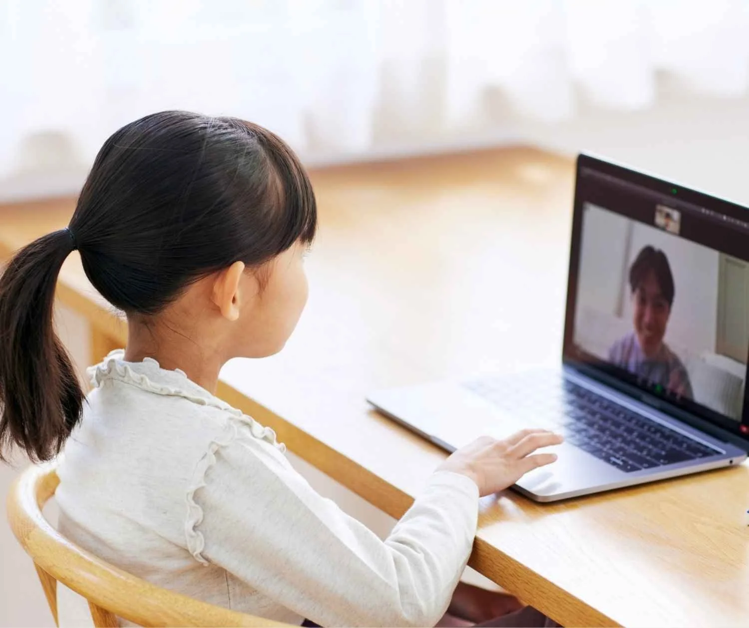 young child on a video call speech session at home, smiling