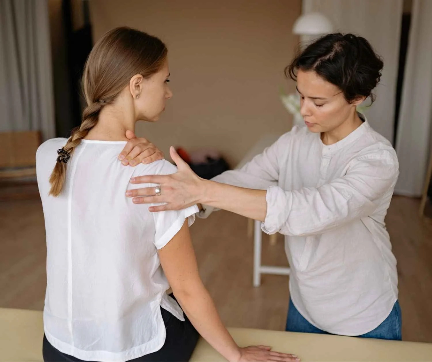 physical therapist hands on adult neck shoulders