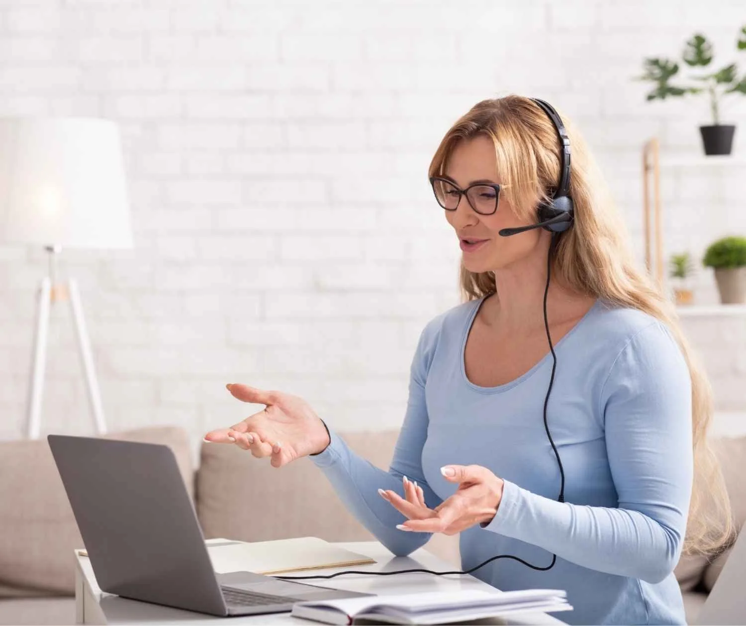 A woman using the laptop with a headset