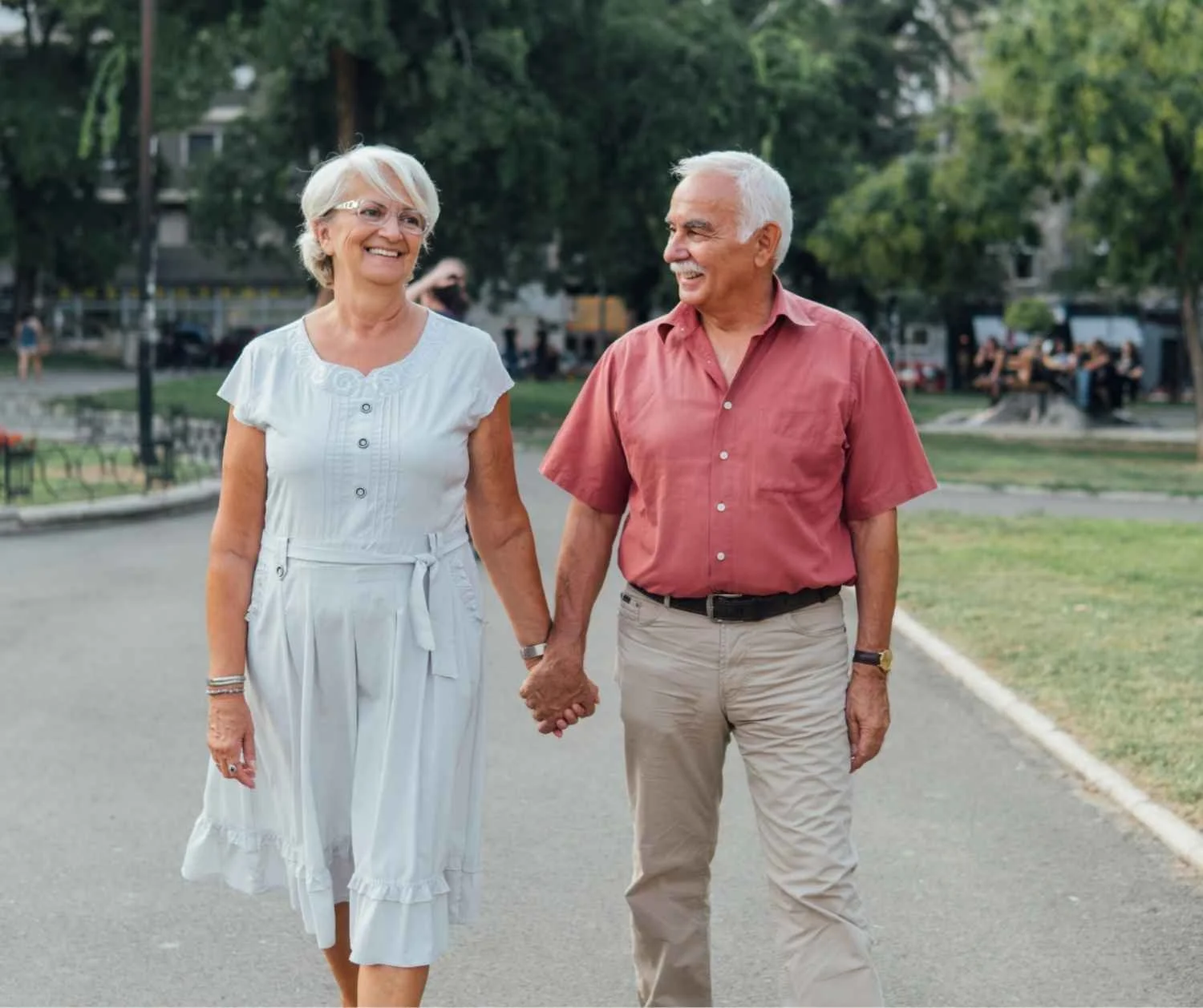 Older couple walking outside and talking closely