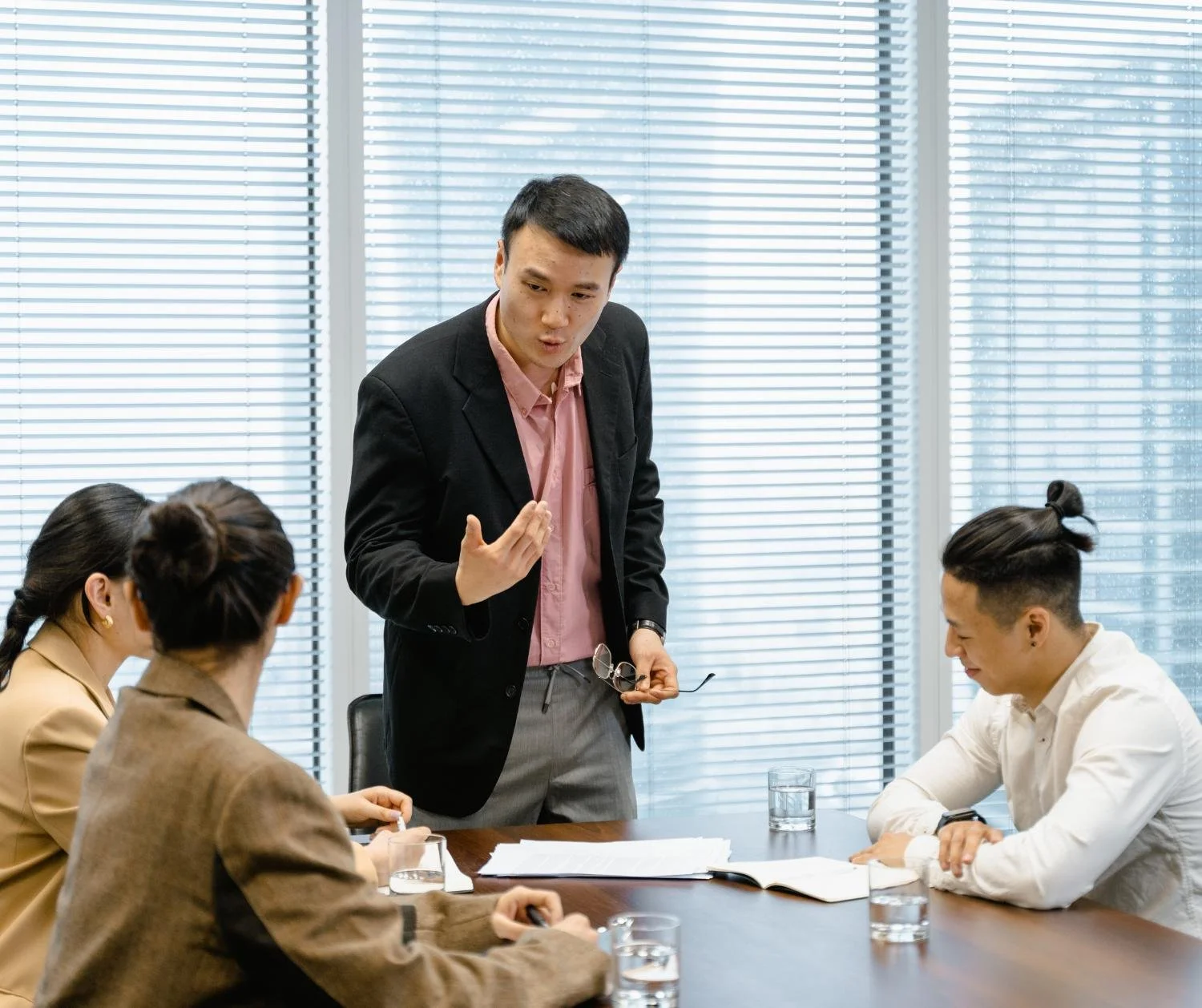 A man in a suit explaining something to his team