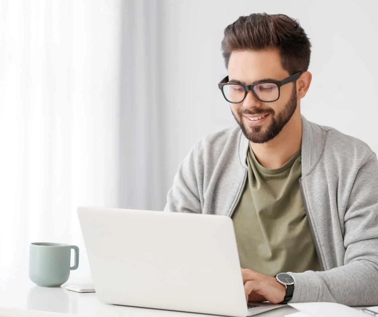 young man practicing a presentation at a laptop