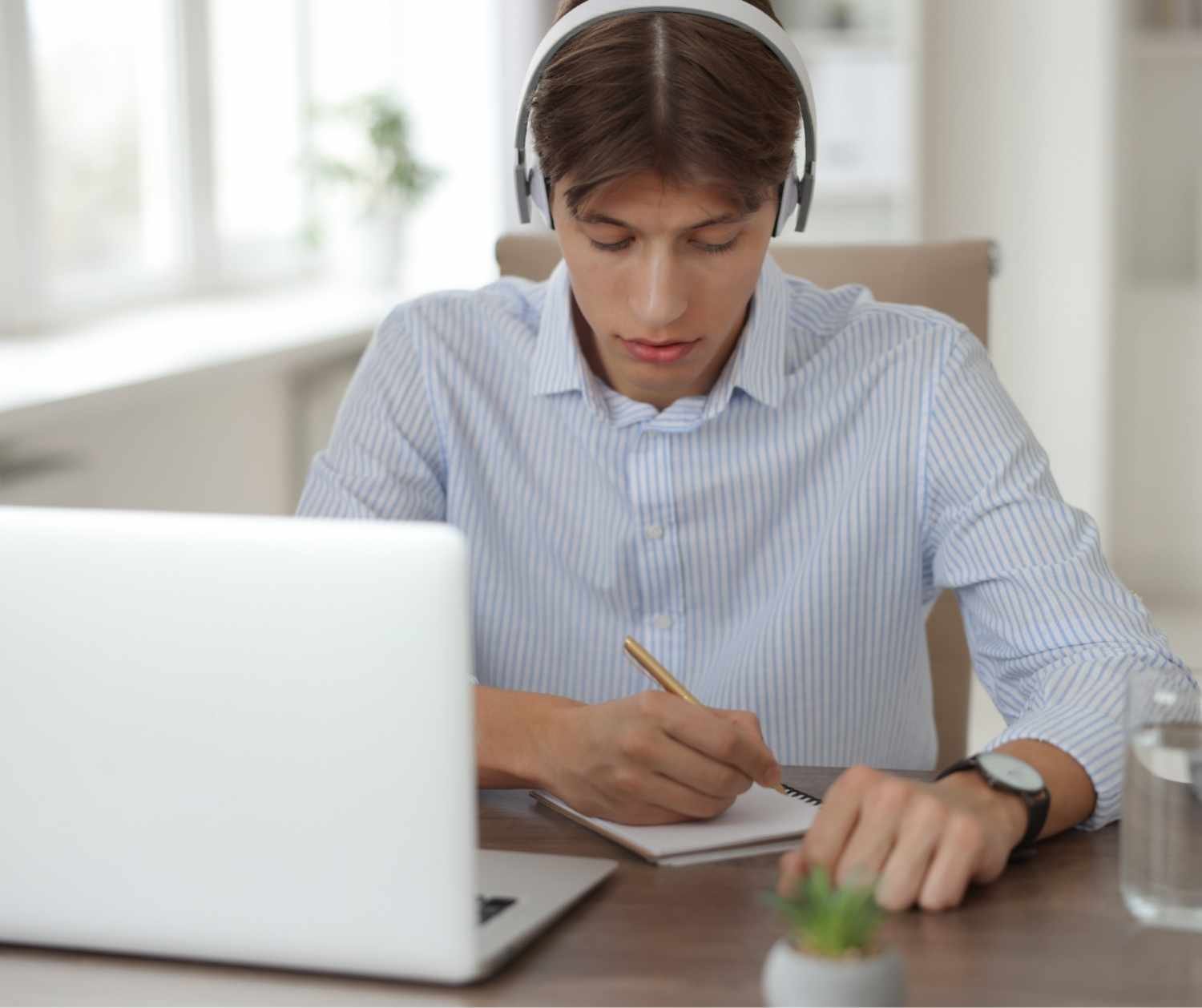 Man taking notes at his kitchen table.
