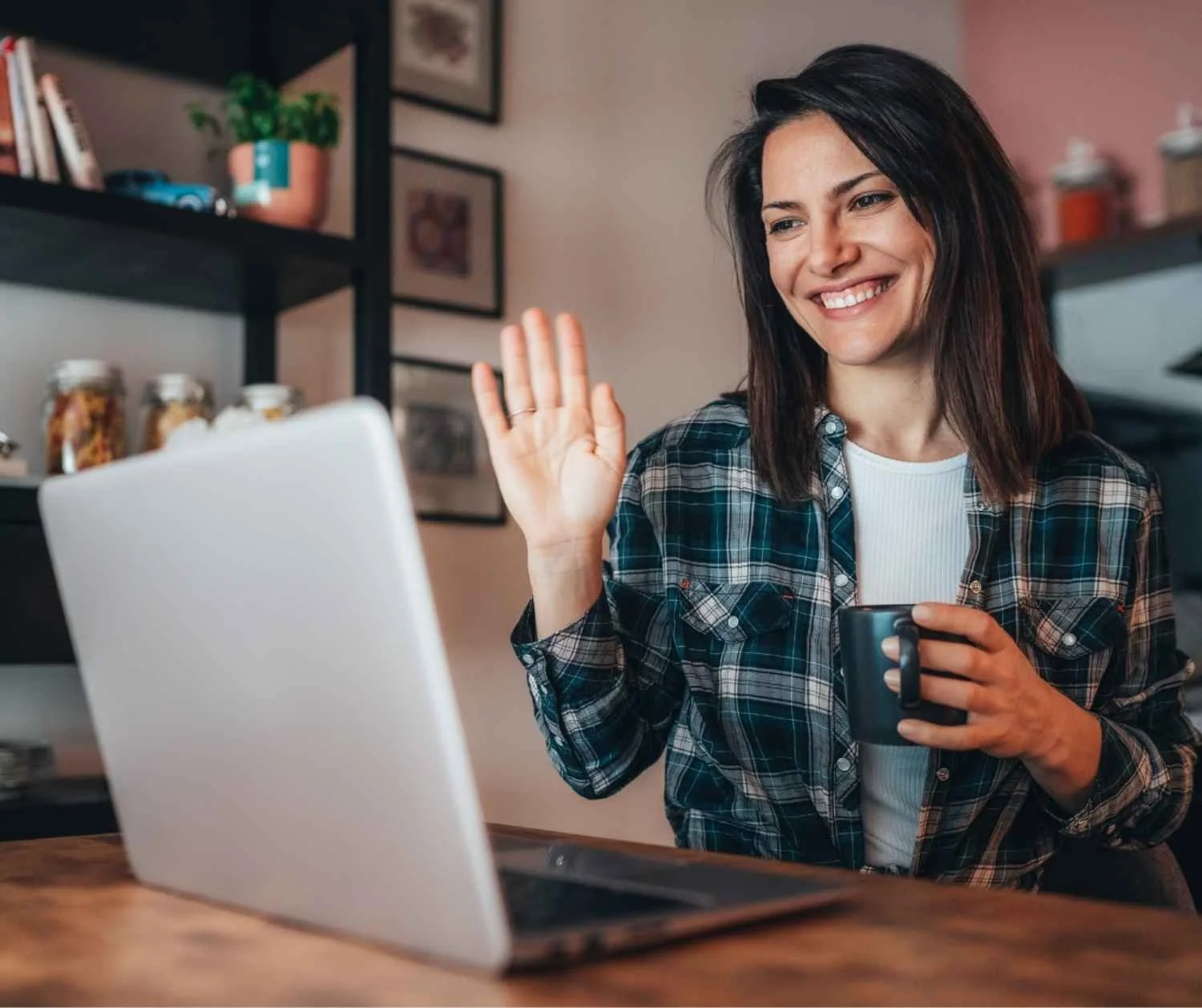 adult client smiling during an online speech therapy video call at home